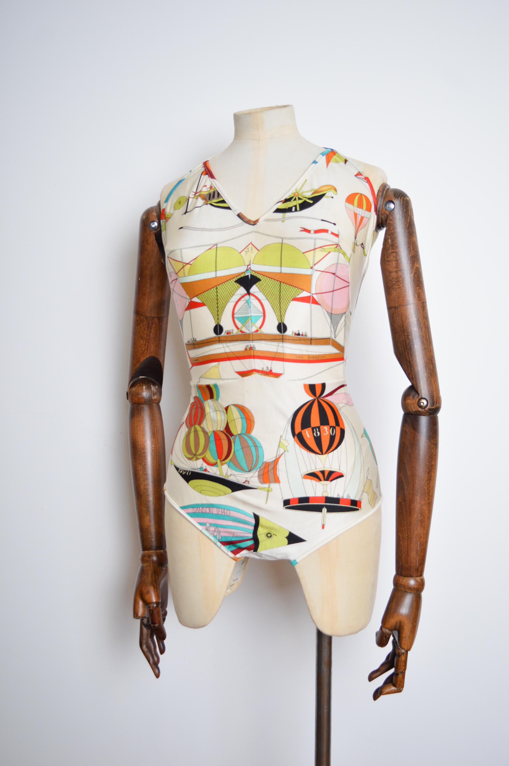 Whimsical Vintage HERMÈS PARIS bathing suit circa 1970, in a beautiful Hot Air Balloon 'Loic Dubigeon' scarf print.

MADE IN ITALY.

Features; Halter Neck collar line, Backless reverse, Full Print through Out.

Sizing; 
Waist approx 32