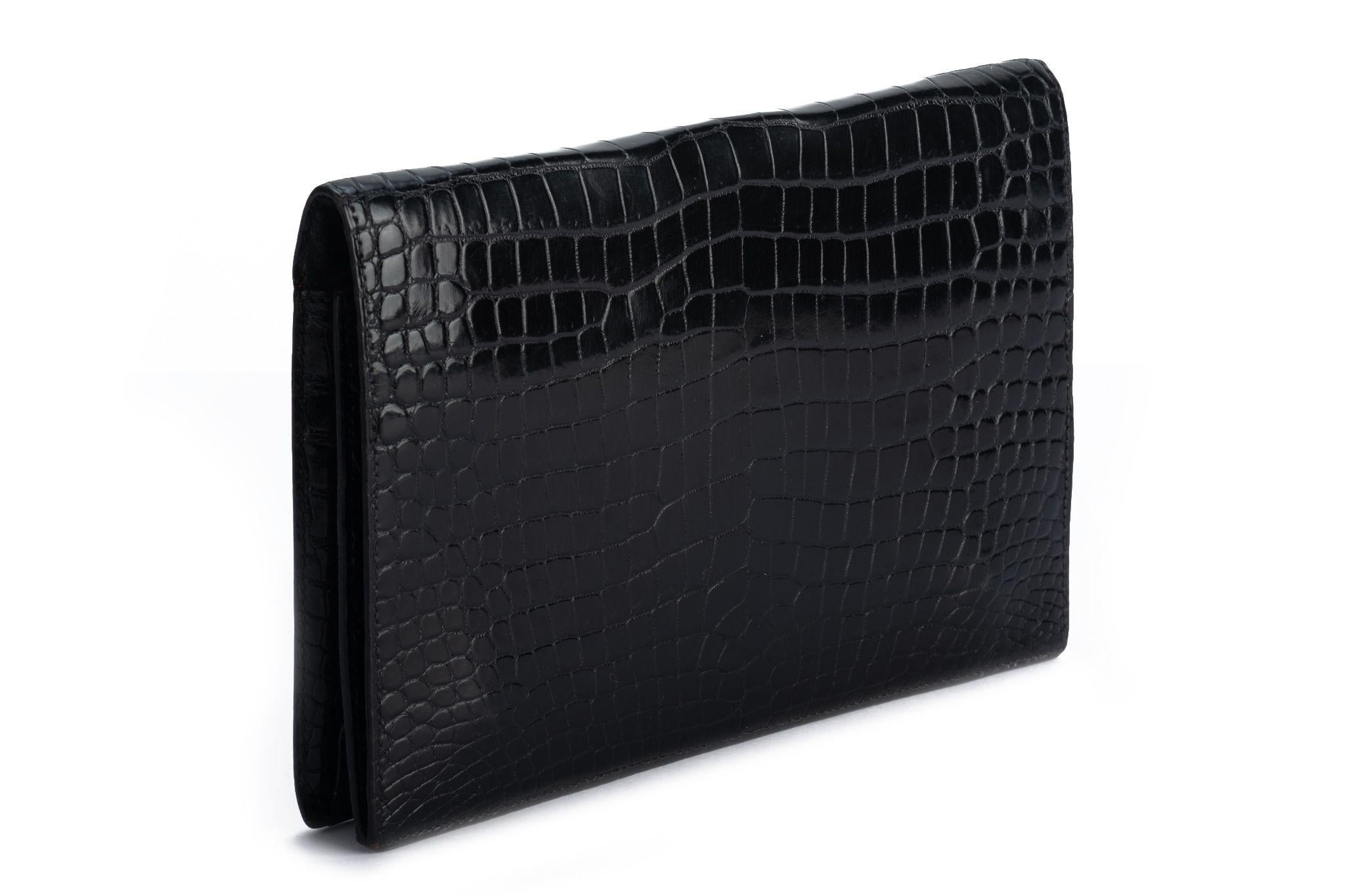 Hermes vintage black crocodile clutch with gold tone hardware. Pre stamp production, comes with original dust cover.