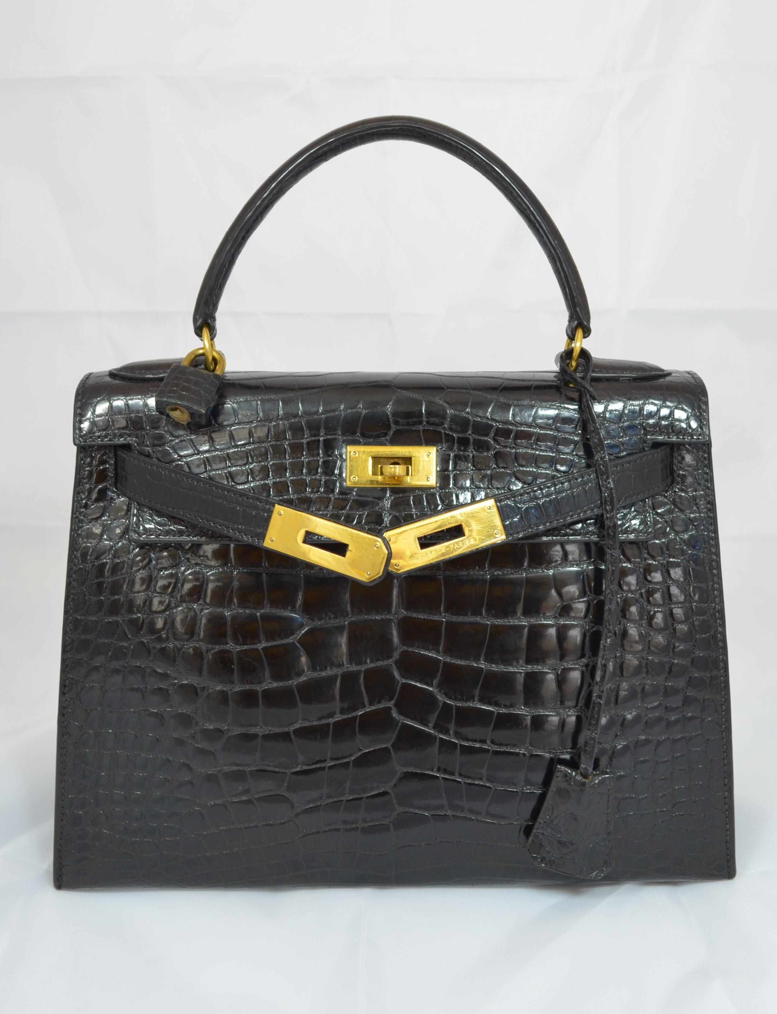 Vintage Hermes Kelly bag 28cm featured in black crocodile skin with gold hardware. Bag is in wonderful vintage condition with some normal but light wears throughout. There are no major flaws to mention. Includes original dustbag. Made in France, V
