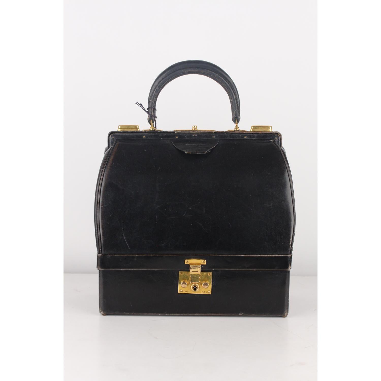 Vintage Hermes 'Sac Mallette black leather structured handbag with bottom compartment.The bag was particularly favored by wealthy women in the 1950s and 1960s who, when traveling, could carry their fine jewelry with them. Upper push closure + double