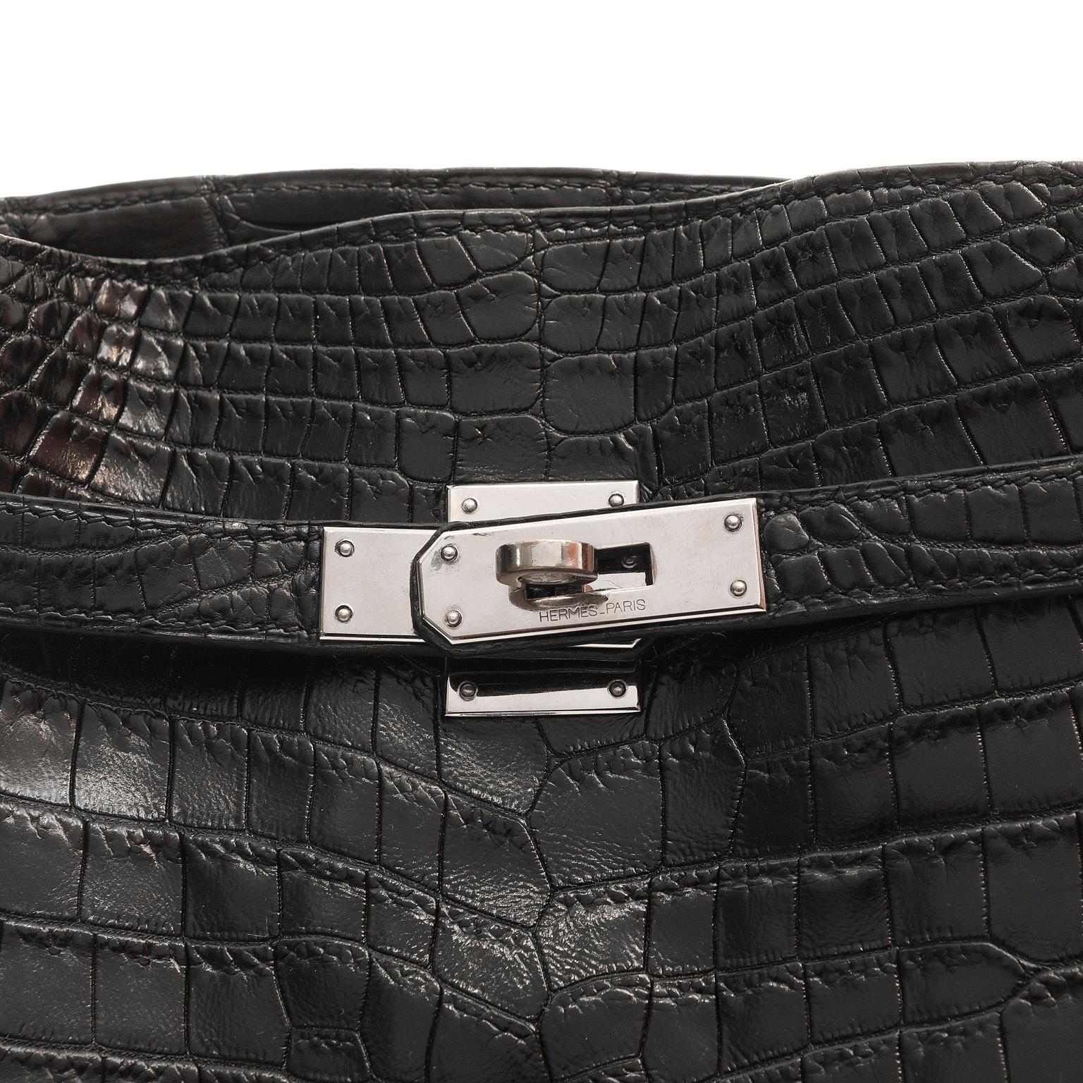 This authentic Hermès Vintage Black Niloticus Crocodile 26 cm Kelly Sport is in excellent plus condition, nearly pristine.  This style is no longer in production and highly collectible.  

Hermès bags are considered the ultimate luxury item the