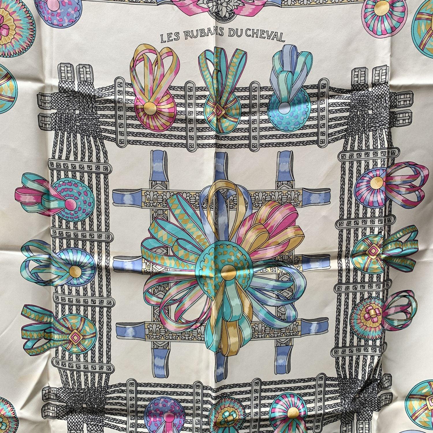 HERMES scarf 'Les Rubans du Cheval' (Horse ribbons) by Joachim Metz and originally issued in 1988, and reissue in 1989 and 1993. It is a truly classics of Hermes maison. This design depicts cockades or prizes won by horses. Black borders. 100% silk,