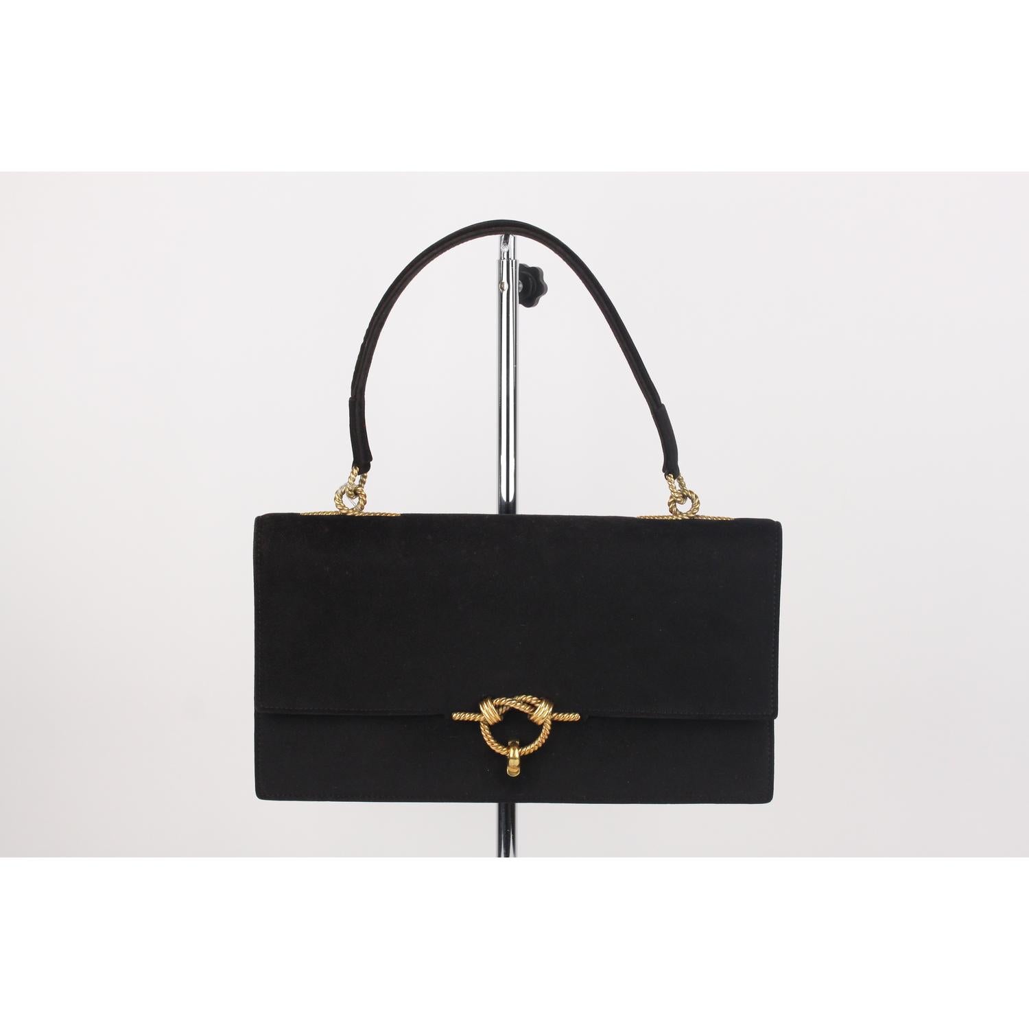 Vintage Black suede 'Cordelière' bag from Hermès from the 1960,  featuring a top handle, a fold-over flap top with gold rope clasp closure.  This opens to a black leather interior with 3 side open pockets and 1 side pocket with flap. 'HERMES Paris'