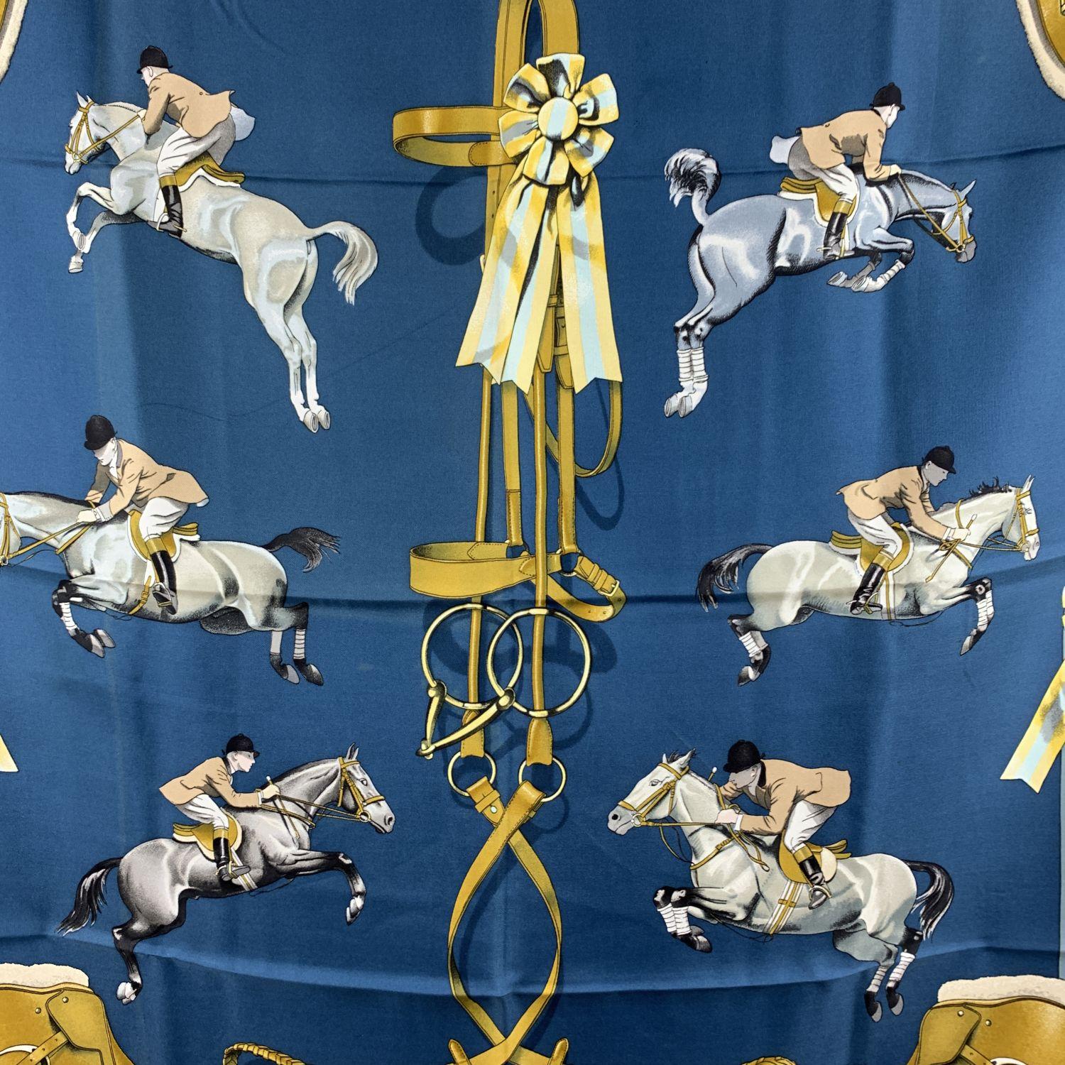 Vintage HERMES Silk scarf named 'Jumping' by Phippe Ledoux. First issued in 1971 and then 1975. Equestrian theme. The border of the scarf is in light blue color. 100% silk. 'HERMES Paris' with copyright symbol printed in the lower right corner.