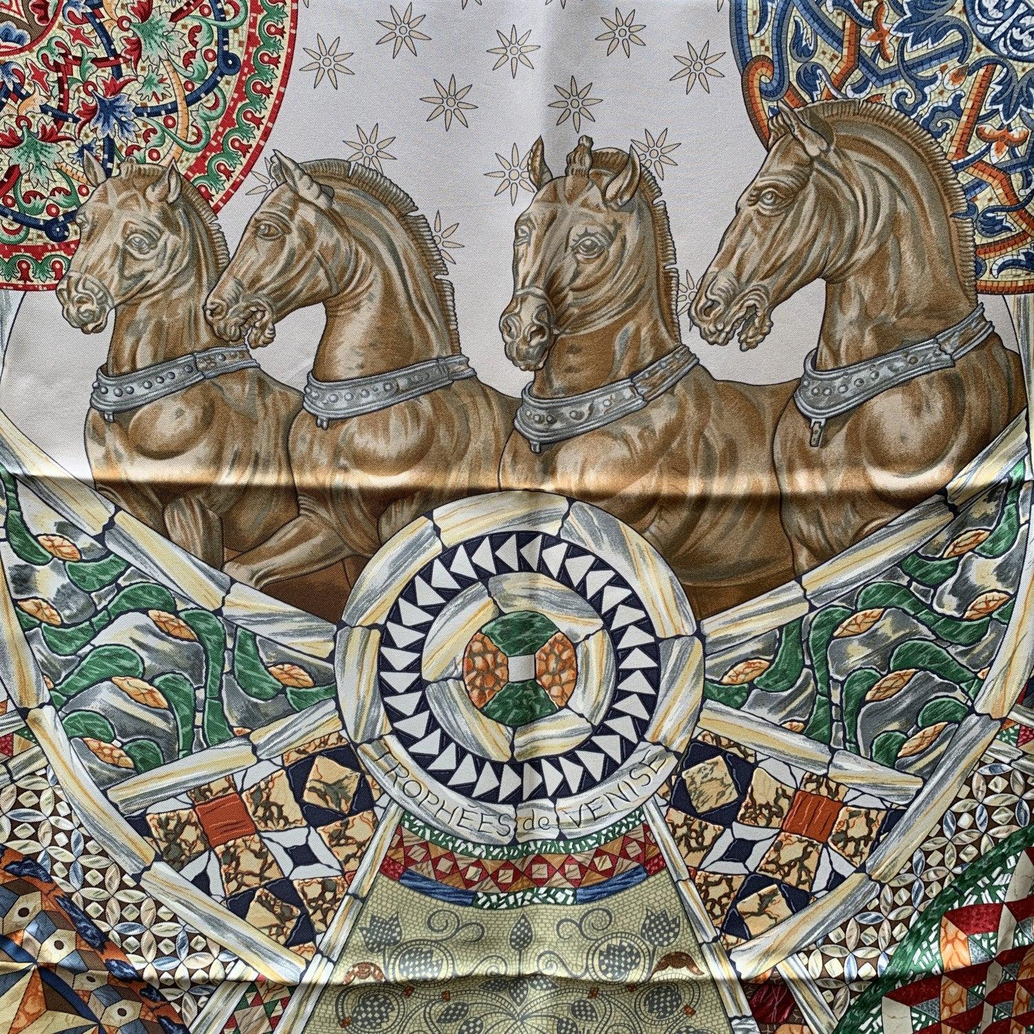 Stunning Hermes ' Trophees de Venise' silk scarf designed by Julie Abadieand originally issued in 2002. It depicts well-known iconic symbols of Venice. Blue border. 100% Silk. Composition tag is still attached. Hand rolled edges. Details MATERIAL: