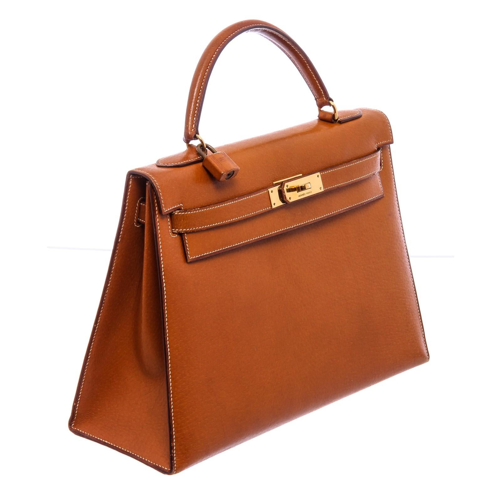 Brown Barenia leather Hermès Kelly Sellier 32 with gold-plated hardware, single flat top handle, protective feet at base, tonal leather lining, three interior pockets; one with zip closure and turn-lock closure at front. Include Lock, Keys and