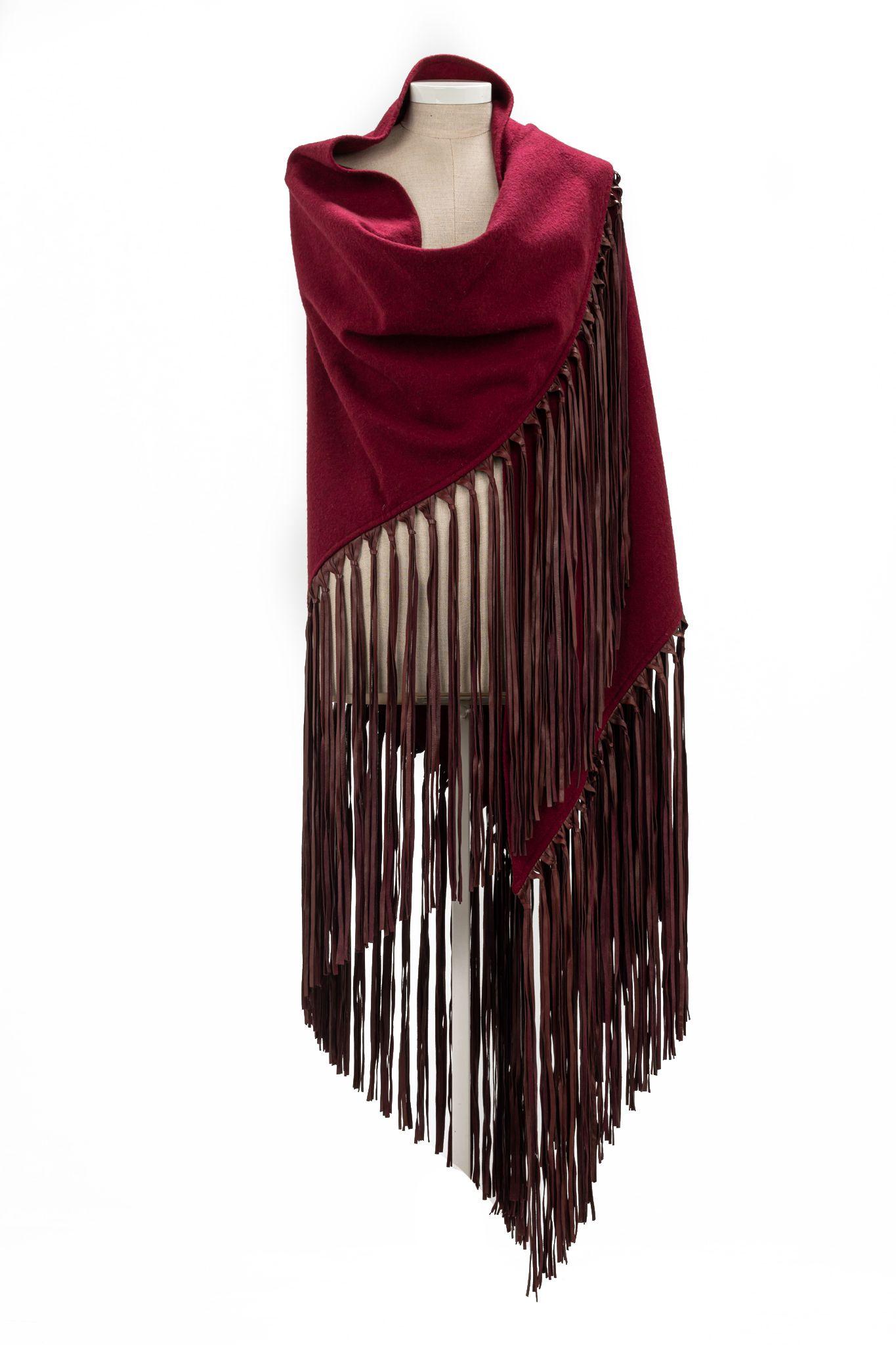 Hermès Tassle Cashmere shawl in burgundy red. The shawl has leather fringes. Piece is in excellent condition.