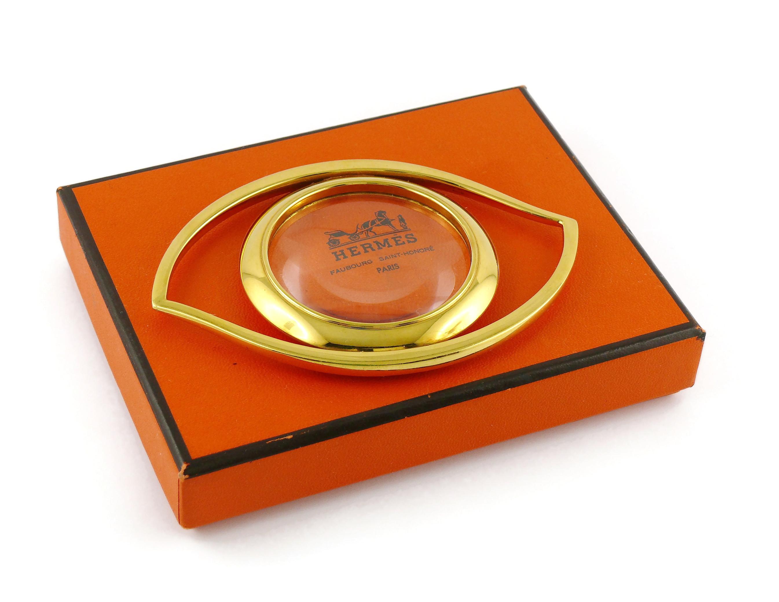 HERMES vintage gold plated desk magnifying glass and paperweight featuring a massive Cleopatra Eye.

Designed in the 1960’s by JEAN COCTEAU for HERMES. This piece is directly inspired by the Egyptian Mythology and surrealist movement.

Embossed