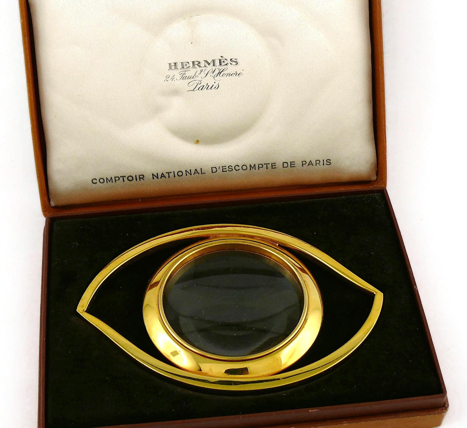 HERMES vintage gold plated desk magnifying glass and paperweight featuring a massive Cleopatra Eye.

Designed in the 1960’s by JEAN COCTEAU for HERMES. This piece is directly inspired by the Egyptian Mythology and surrealist movement.

Embossed