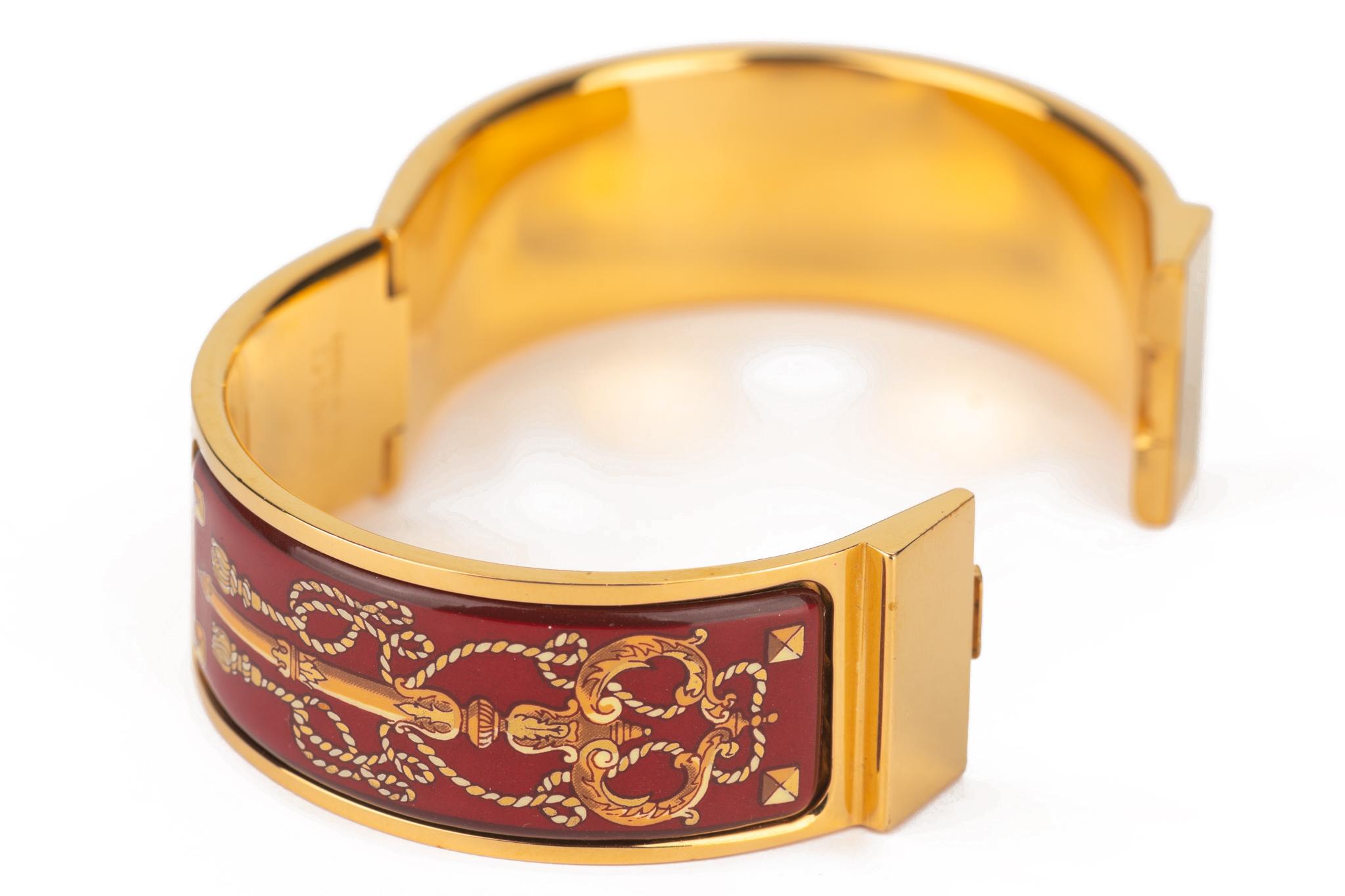 Hermès vinatge Cloisonne Enamel Bangle, features a burgundy and gold print with gold plated borders. A classic piece that can be worn casual or elegantly. Comes with original box.