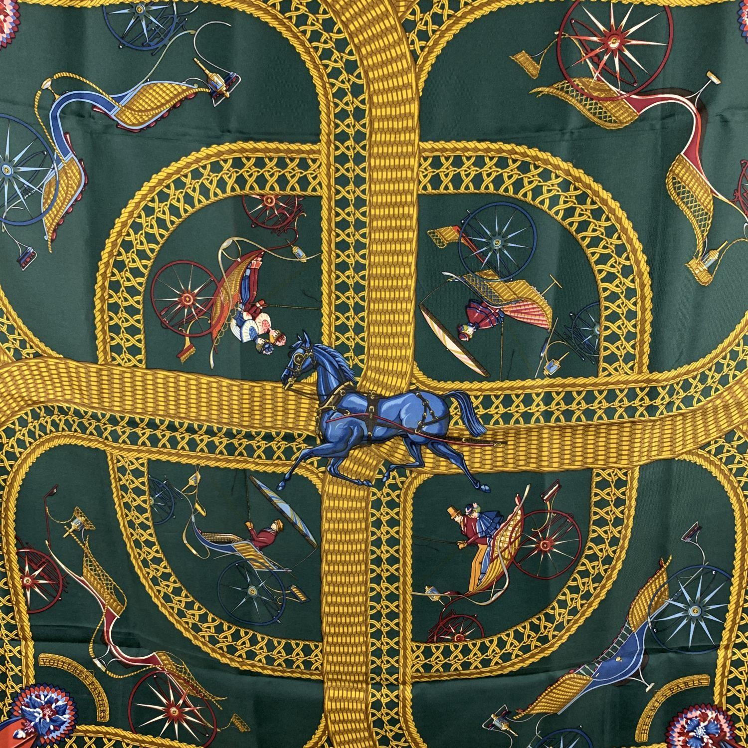 HERMES silk scarf named 'Voitures Paniers' designed by Julie Abadie and issued the first time in 1984. It has re-issued in 1990/1991. It depicts some wicker carriages. Main colors are dark green, yellow and red. Hand rolled edges. Measurements:
