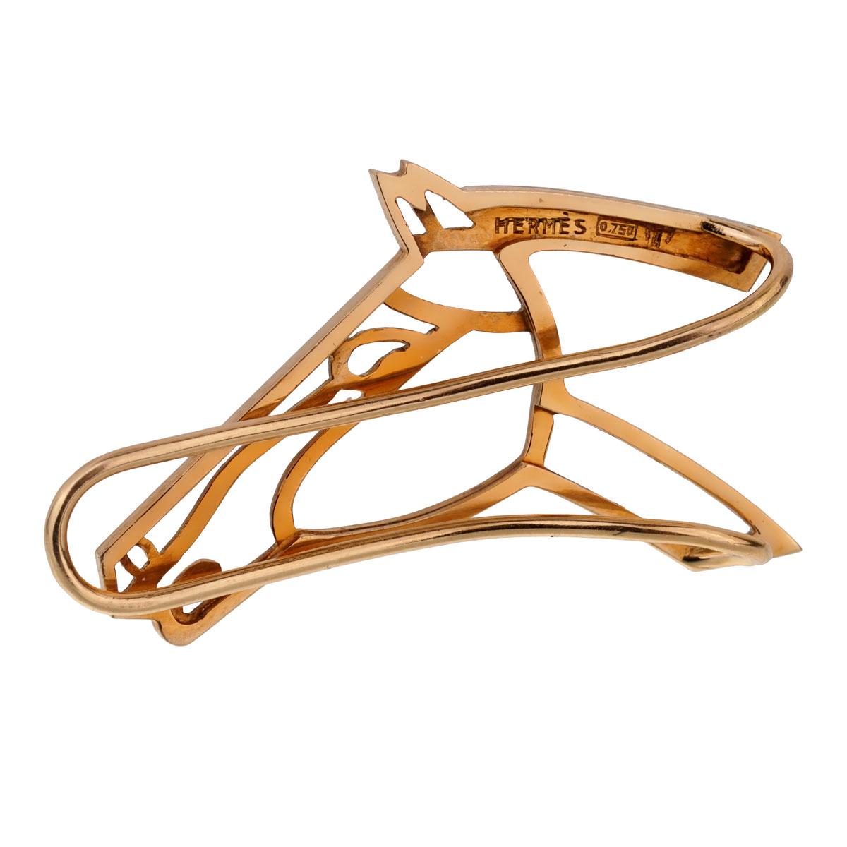 An amazing Hermes money clip outlining a horse head motif in 18k yellow gold.