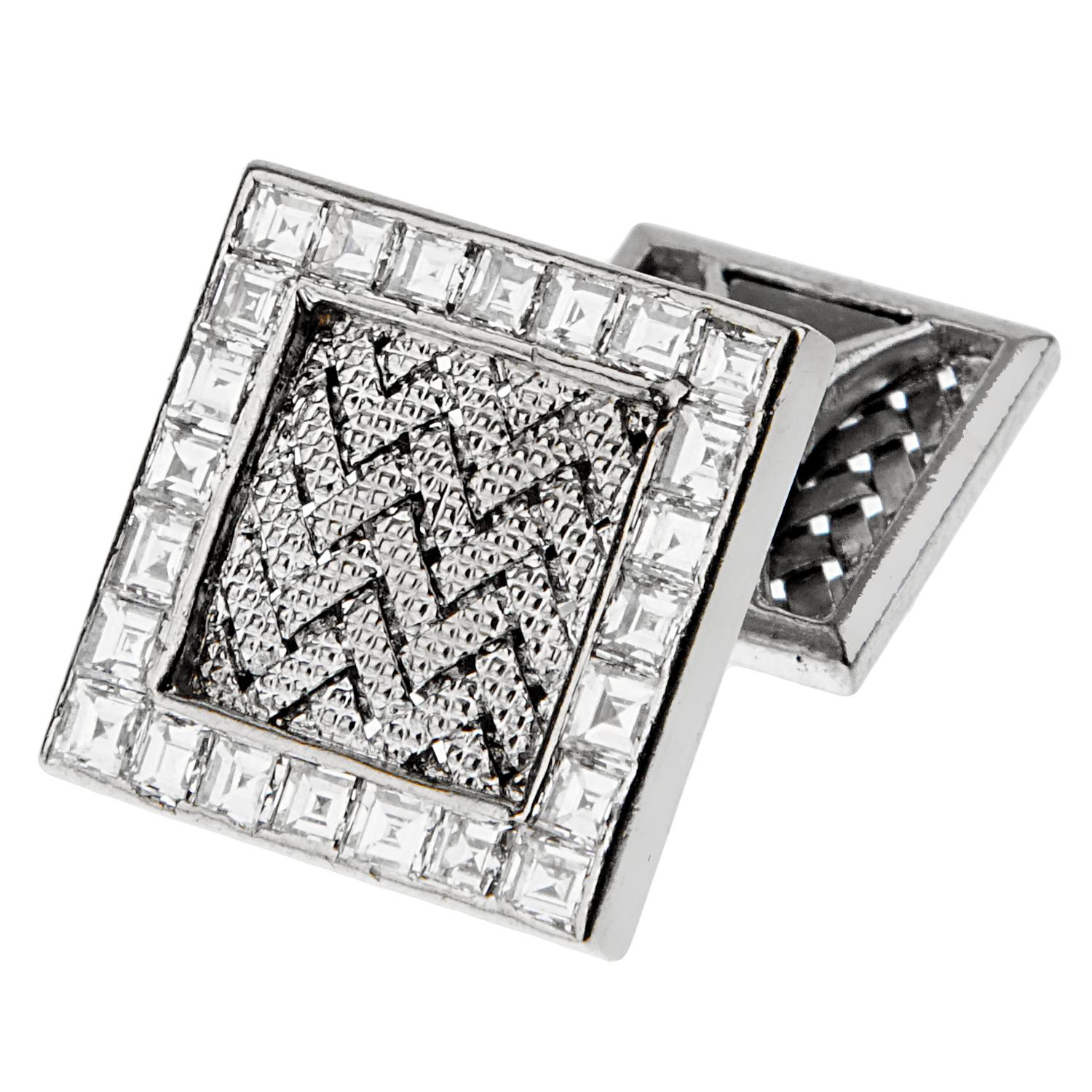 An important pair of vintage Hermes cufflinks showcasing a braided center motif adorned with a row of calibre cut diamonds appx 2ct. The earrings are crafted in 18k white gold, and are fully hallmarked.