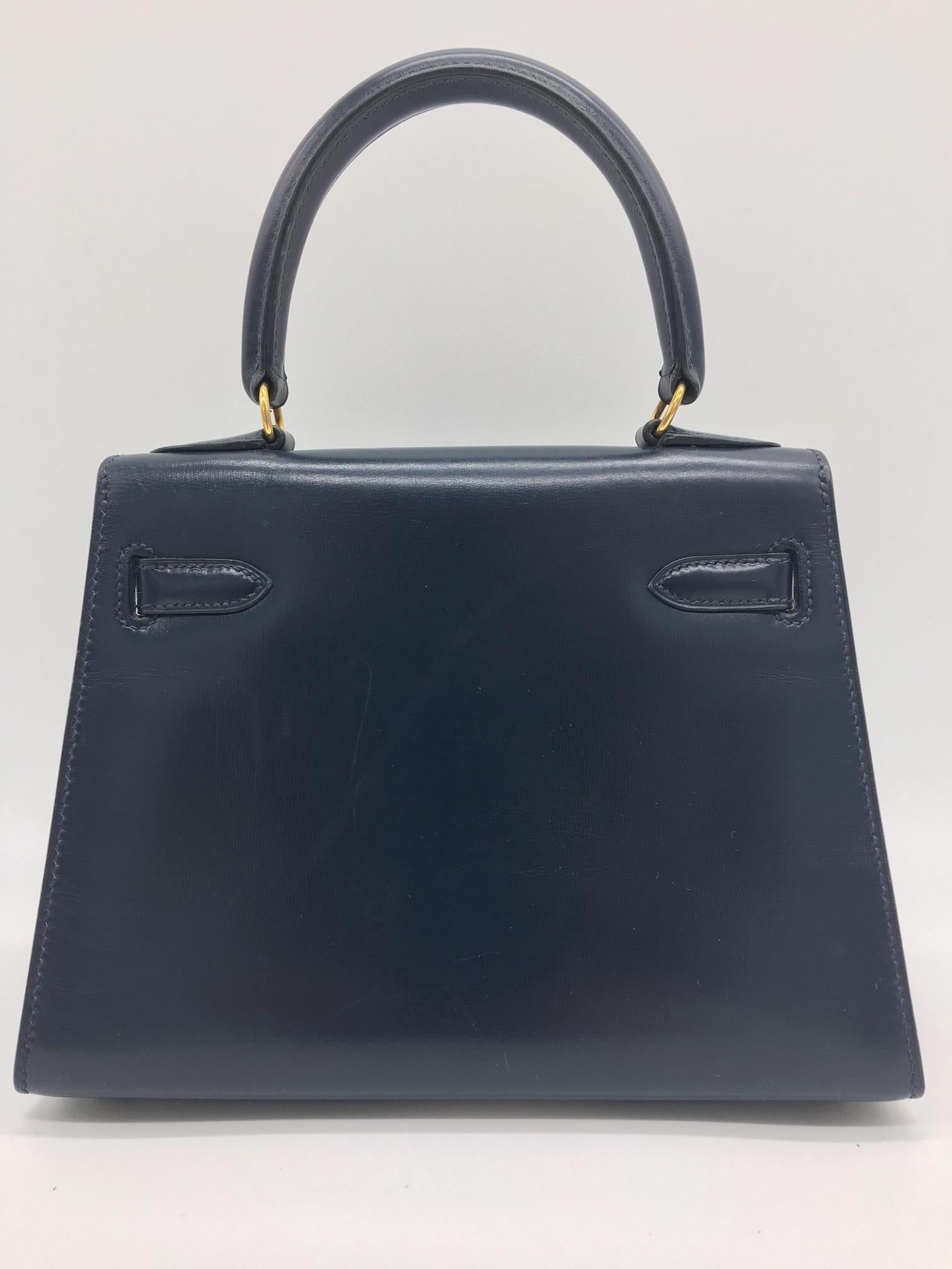 These beautiful bags are no longer made so are very sought after and we are lucky enough to have this gorgeous little Kelly in very dark blue available. S stamp, in good condition with just a few scratches on the leather and hardware, in keeping