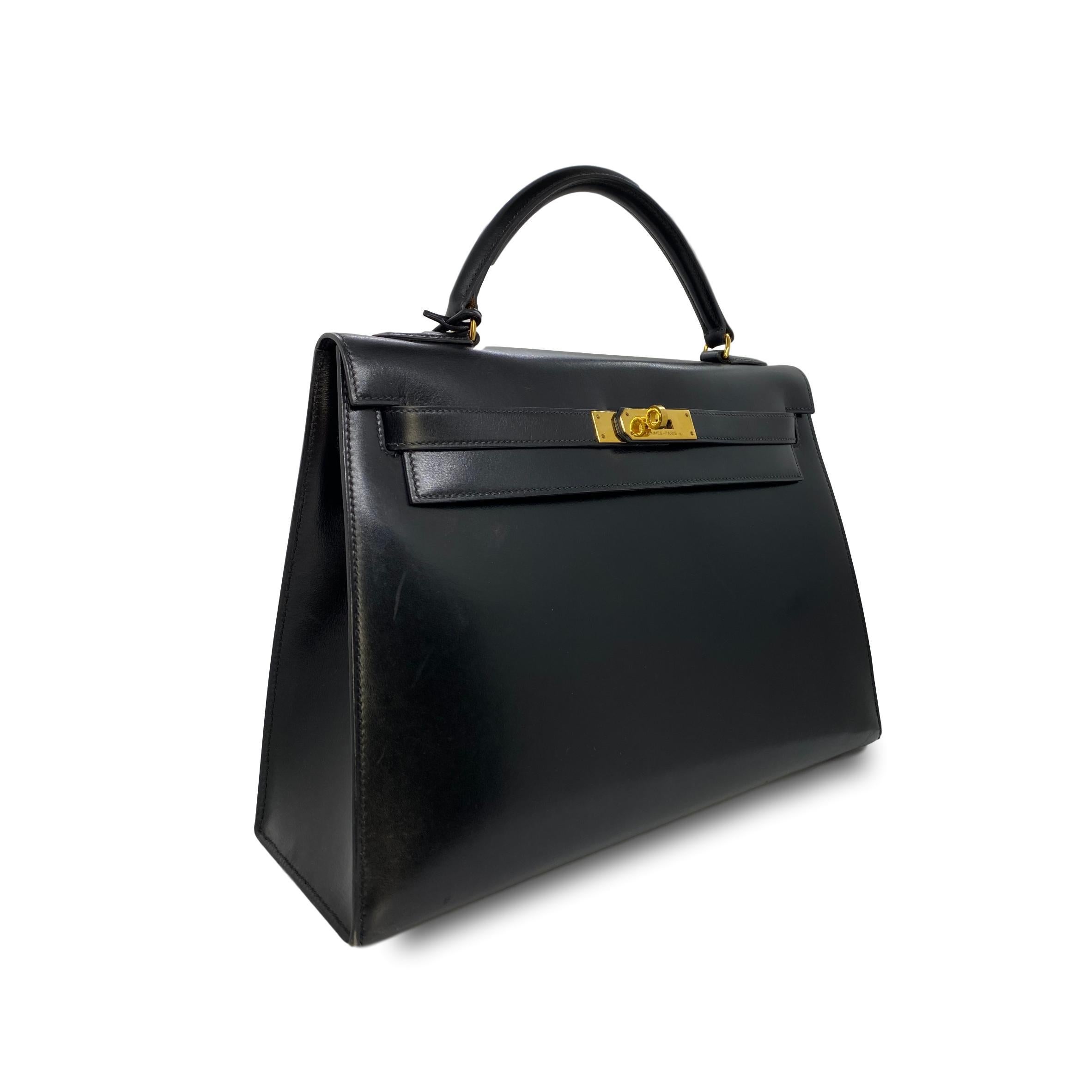 Hermes Vintage Kelly Handbag Noir Black Box Calf with Gold Hardware 32, 1991. Hand crafted in France from premium box calf leather with adorning gold plated hardware. The Hermes Kelly Handbag is an iconic fashion staple, named after Grace Kelly,