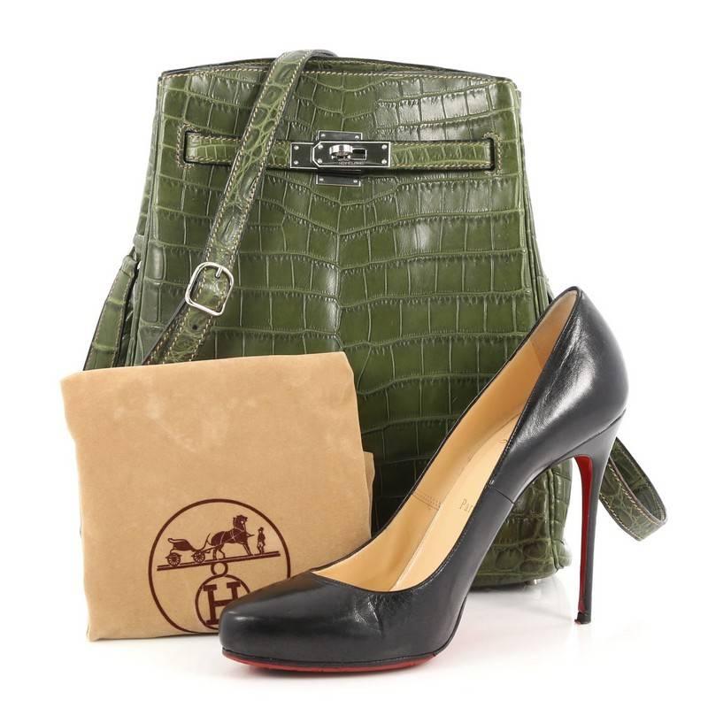This authentic Hermes Vintage Kelly Sport Handbag Niloticus Crocodile 26 is considered as one of the ultimate luxury items from Hermes. Crafted in genuine Vert Olive niloticus crocodile skin, this chic bag features adjustable shoulder strap,