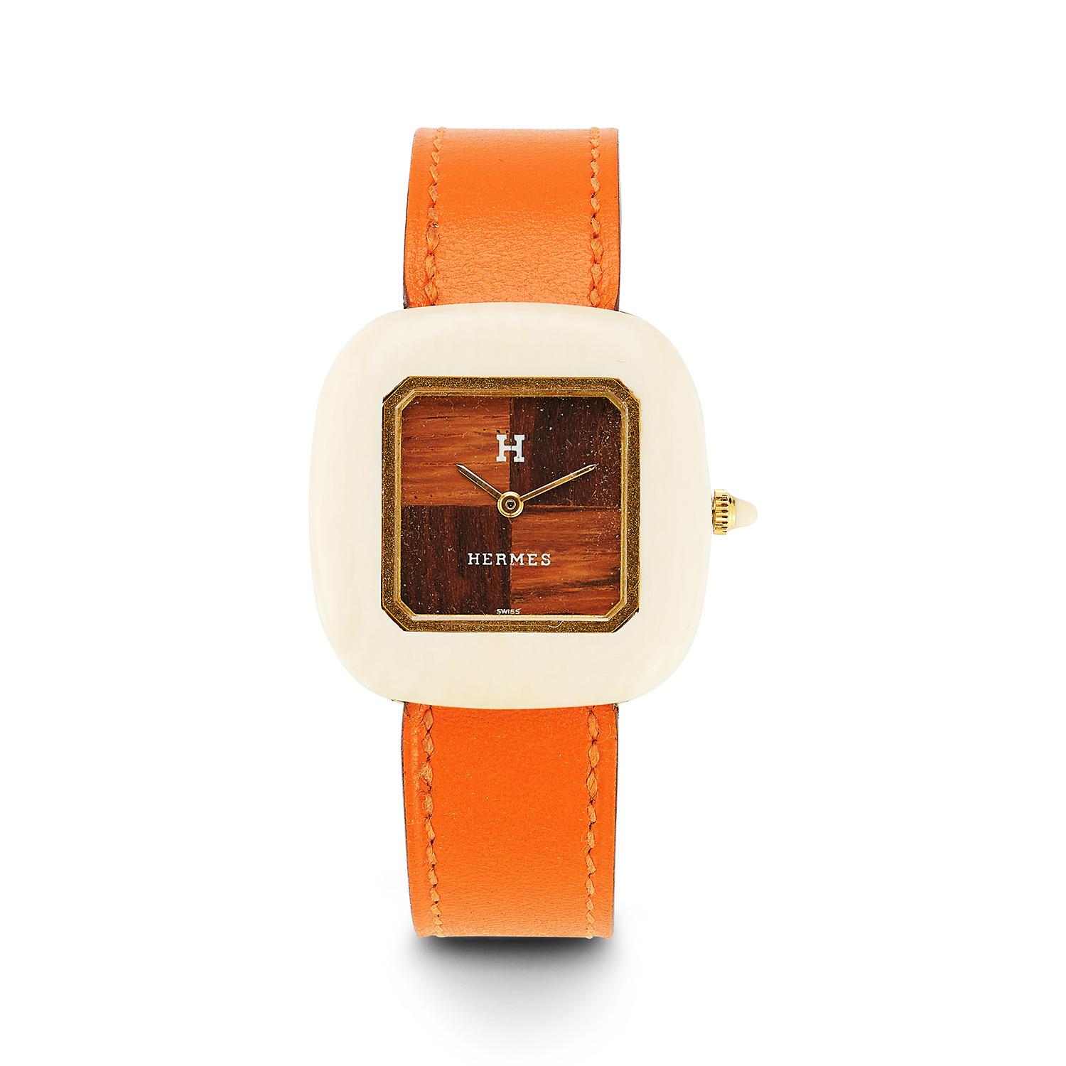 This Hermès one-of-a-kind watch is a perfect fit for the Hermès enthusiast or watch collector. Believed to be a piece commissioned in the 1960's, this Hermès watch is comprised of a wide cream color polished bone case with a border lined in gold.