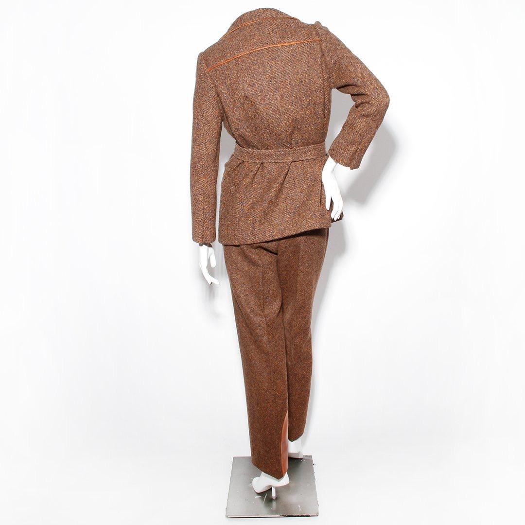 Product Details:
Vintage Ostrich 3 piece suit by Hermes
Circa 1980's
Brown tweed and leather suit  
Silk lining with Hermes logo
Three front pockets on jacket
Leather trim
Open front jacket 
Ostrich and wool vest 
Two front pockets on vest 
Two back