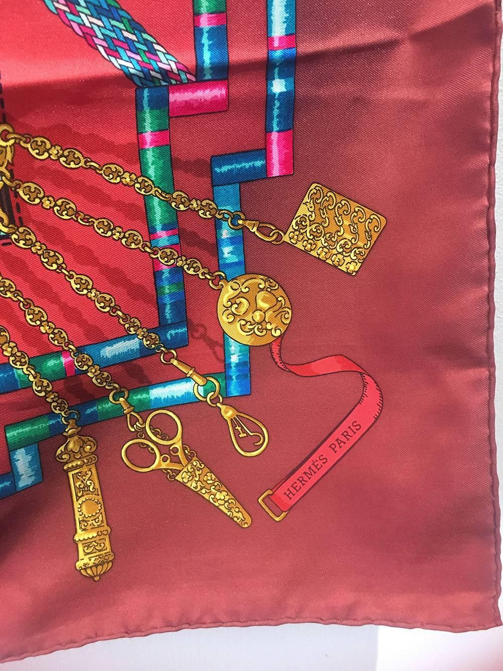 WONDERFUL Hermes Vintage Petit Main Silk Scarf in Dark Red c1980s in excellent condition.  Original silk screen design c1987 by Caty Latham features an arrangement of small bits and bobbles and trinkets of buttons, gold coins and chain and ribbons