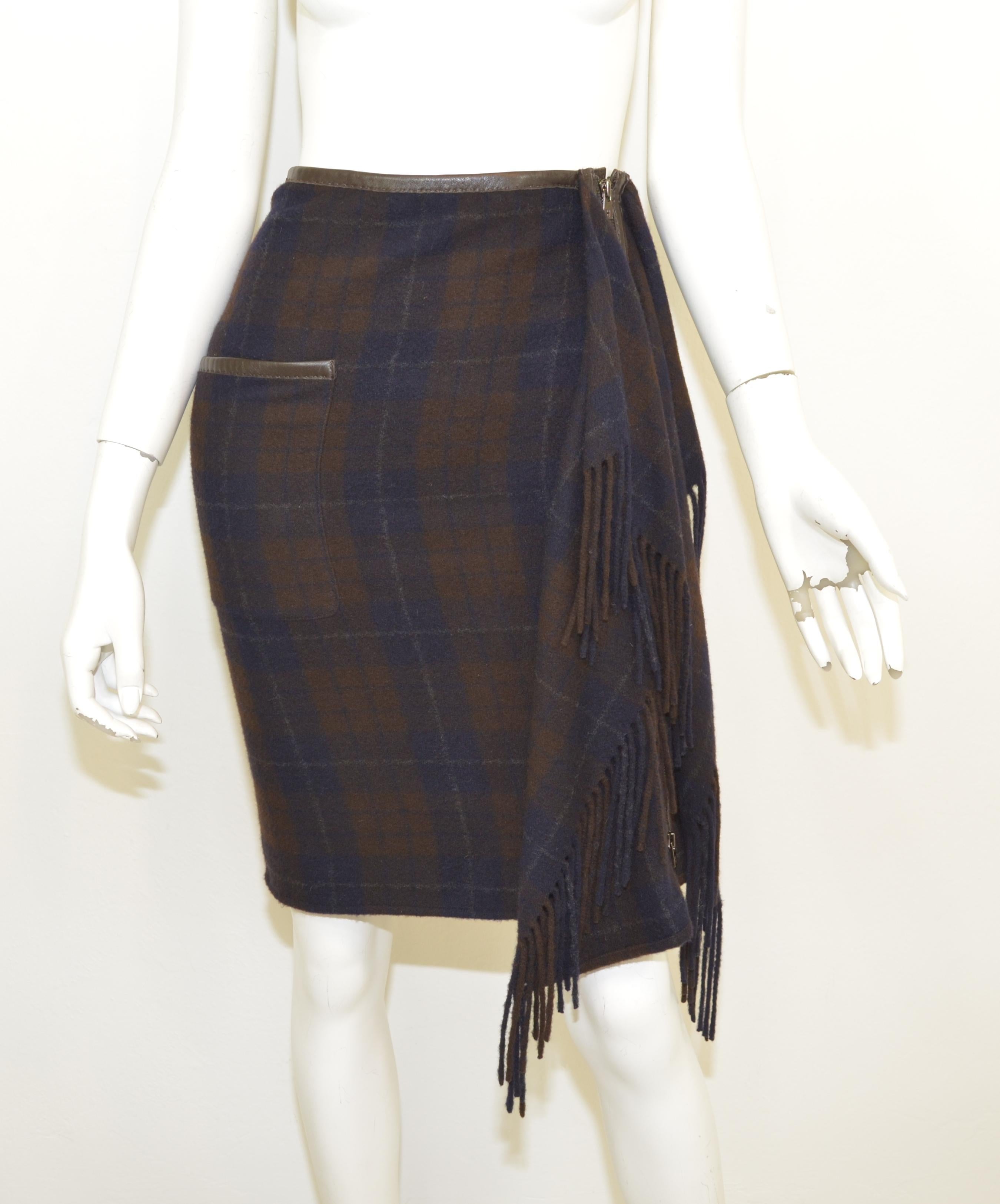 Hermes skirt is featured in a navy and brown plaid pattern throughout with a fringed front panel, leather trimming along the waist line, pocket, and zipper fastening. Skirt is made with 100% cashmere, size 34, made in France. 

Measurements:
Waist