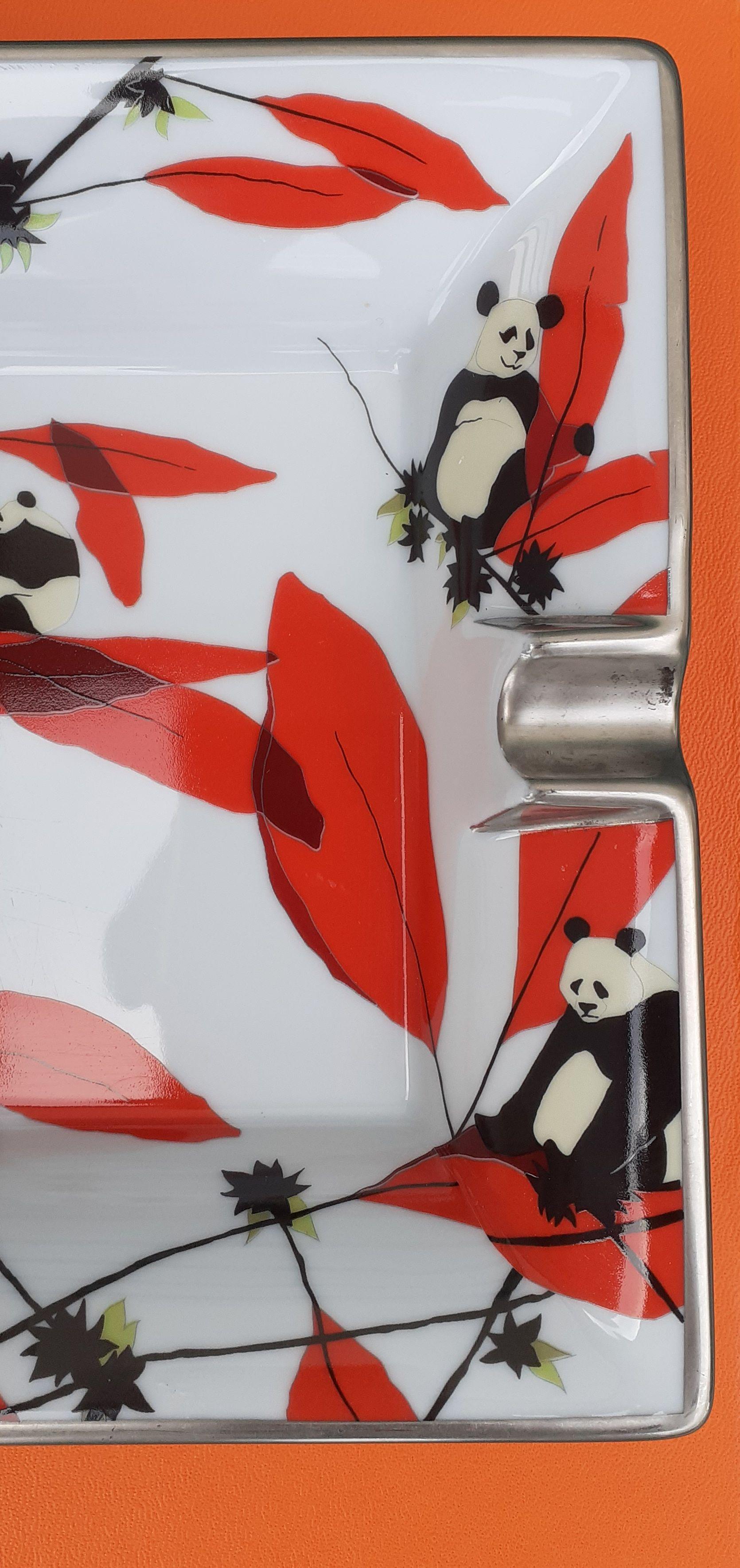 Gorgeous Authentic Hermès Ashtray

Pattern: 8 Pandas and Bamboos

Super cute and rare

Made in France

Made of Porcelain and silver-tone edges

Colorways: White Background, Ivory and Black Pandas, Red and Green Bamboos

Suede Leather at bottom, with