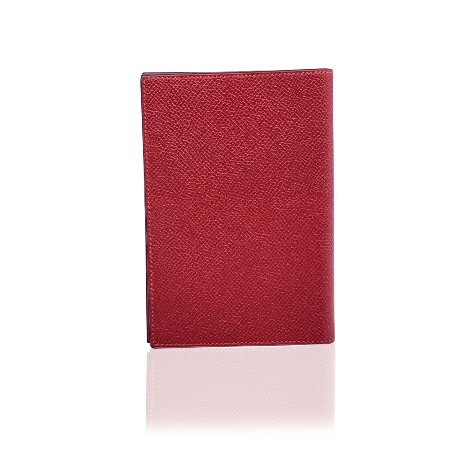 Vintage Agenda/Notebook Simple cover by Hermes crafted in red leather. Silver metal binding in center and 1 slot for a notebook on each side. 'HERMES Paris - Made in France' embossed inside, blind stamp is a 'R' in a Circle (which means that the