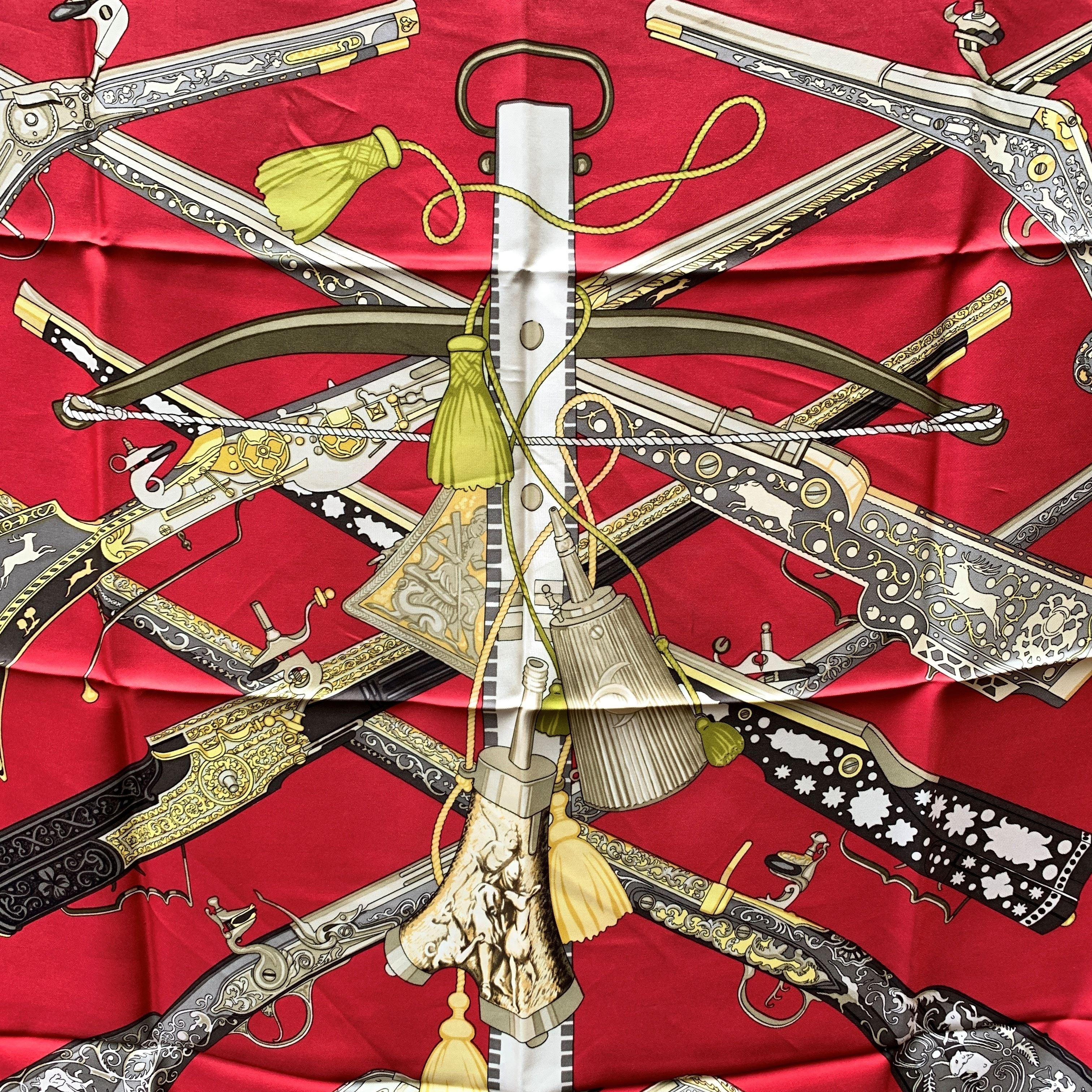 HERMES scarf 'Diane' by Henry De Linares honoring Diana, the Roman goddess of hunting and originally issued in 1972. It features various arms decorated with hunting scenes on a gorgeous red background. 100% silk, hand rolled hem, made in France.