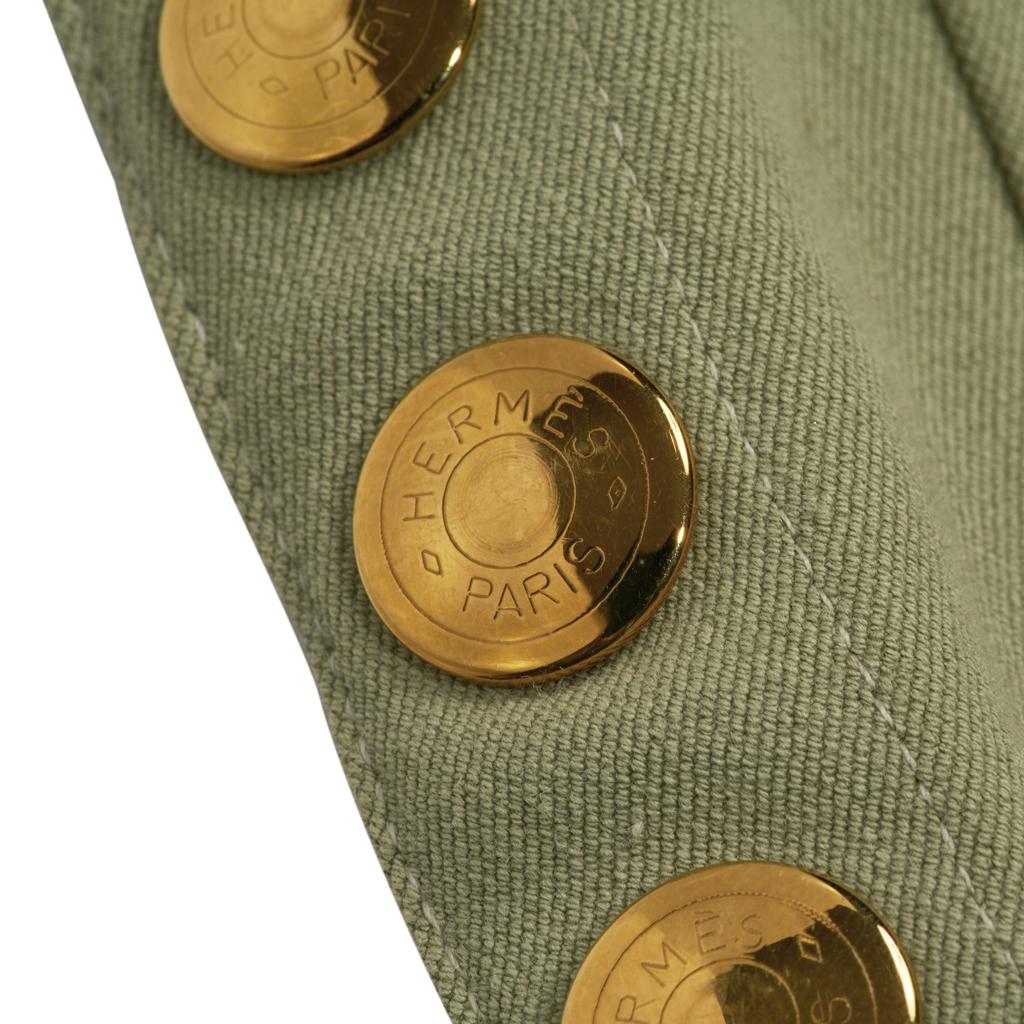 Guaranteed authentic Hermes vintage celadon green riding pant with gorgeous detail. 
Light olive grosgrain trim at ankle with 5 signature gold Clou de Selle snaps. VERY rare to find.
Side zipper with logo embossed snap at waist and embossed button