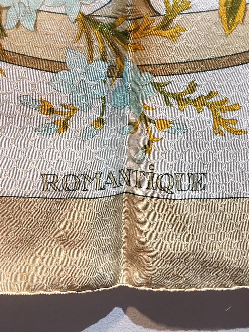 BEAUTIFUL Hermes Vintage Romantique Silk Scarf in beige in excellent condition. Original silk screen design c1973 by Maurice Tranchant features pale yellow, blue and white flowers with green and yellow leaves over a wagon wheel with a white