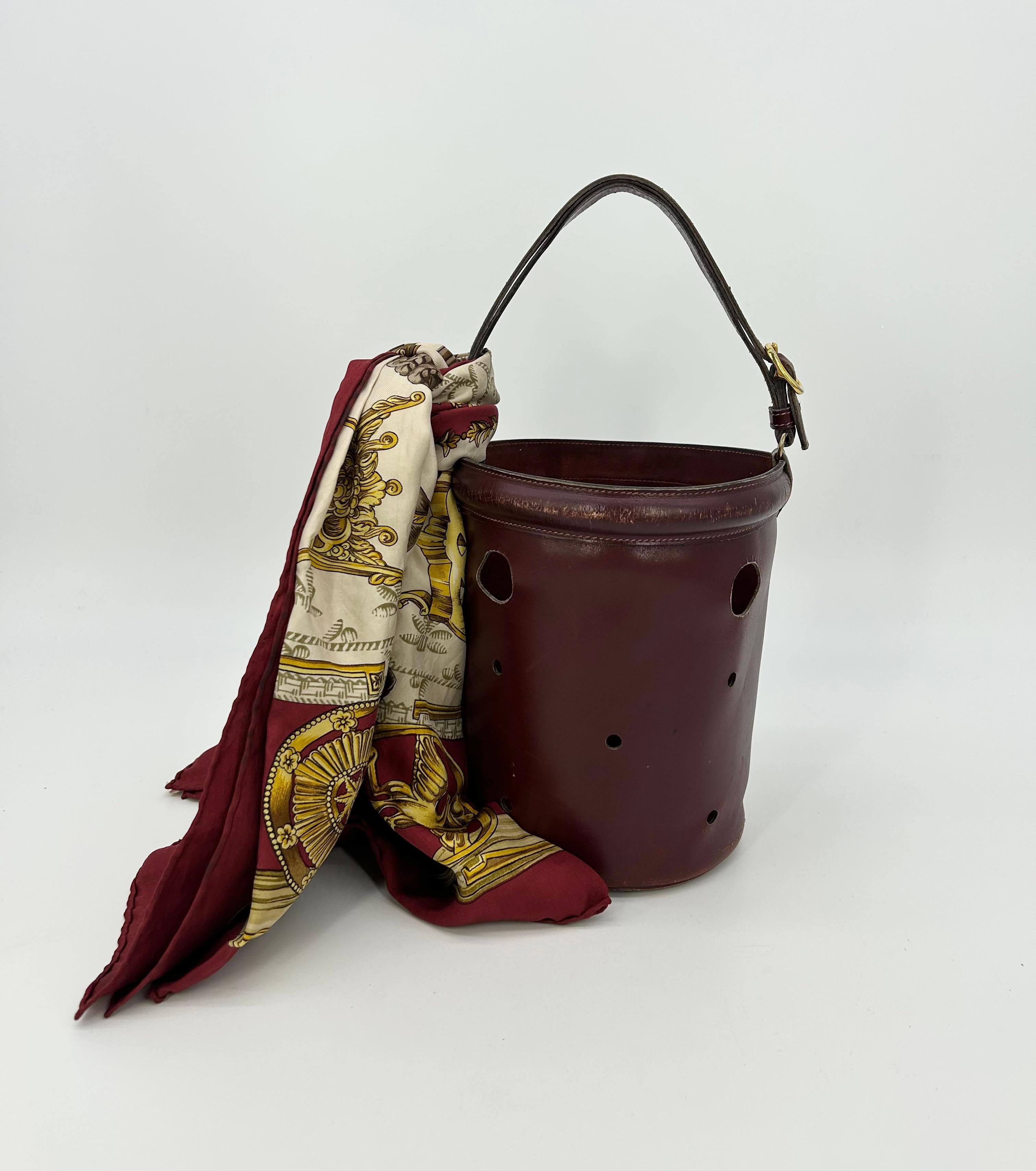 Hermes Vintage Rouge Box Calf Leather Mangeoire Bucket Bag with scarf in fair condition. Deep rouge box calf leather trimmed with golden brass hardware in classic mangeoire holey bucket bag style. Top handle can be lengthened to wear as a shoulder