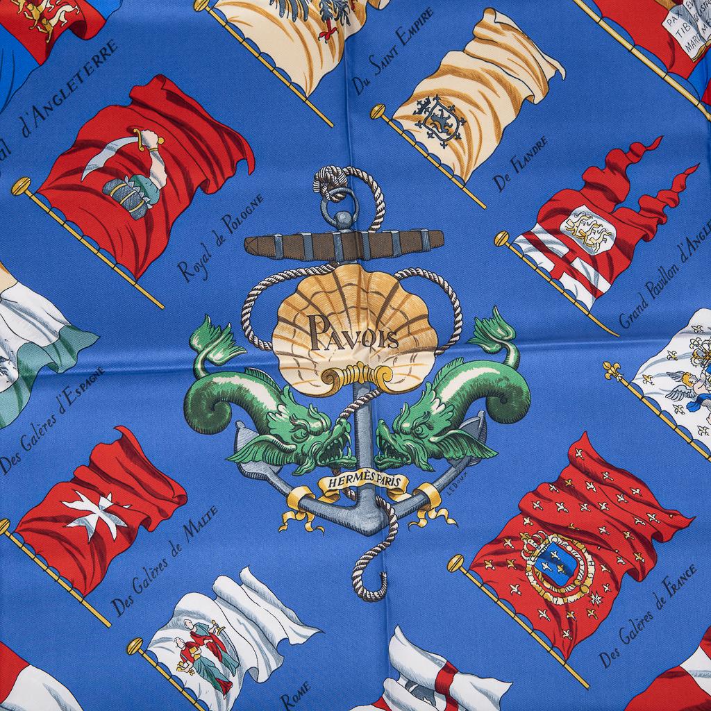 Guaranteed authentic Hermes vintage silk scarf Pavois(Bulwarks)  by Philippe Ledoux.
A rich and vibrant display of 16th century European nations nautical flags.
French blue background with Red, white, gold and blue.
final sale

SCARF MEASURES:
89cm