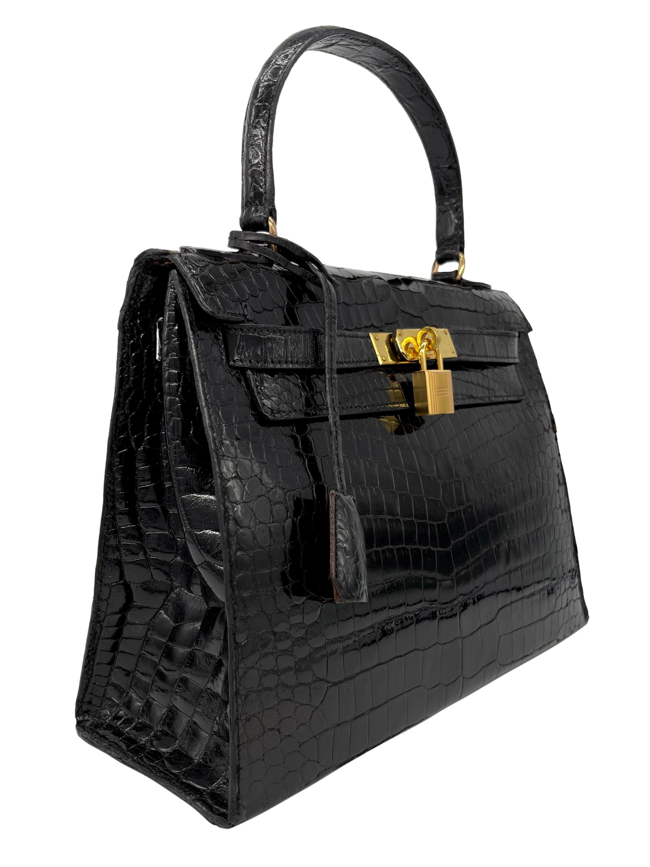 Hermès Rare Vintage Shiny Black Porosus Crocodile Kelly Handbag with Gold Hardware 28cm, 1940. Originally introduced in the early 1930's as the Sac à dépêches bag, the Kelly became world renowned after Grace Kelly, Princess of Monaco appeared on the