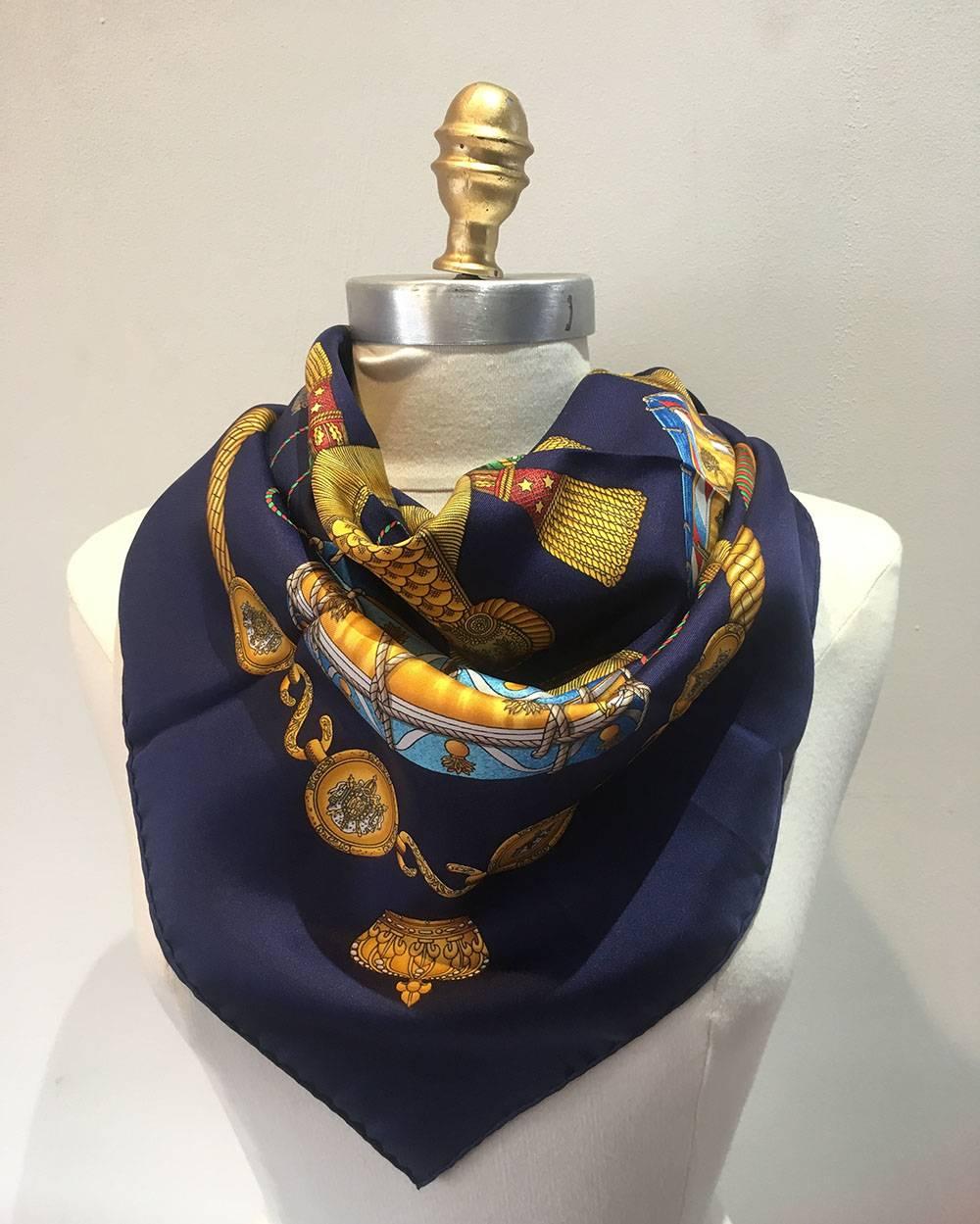 Authentic Hermes silk les tambours scarf in excellent condition. Original silk screen design by Joachim Metz c1989 features a selection of colorful drums over a navy silk background. 100% silk, hand rolled hem, made in france. Excellent condition.