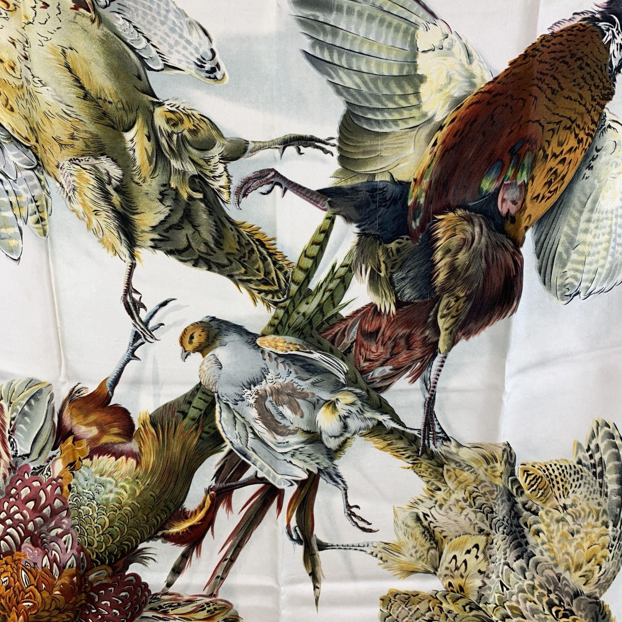 Vintage Herm├⌐s 'Belle Chasse' silk scarf. The scarf was designed by Henri De Linares in 1963. The scarf depicts 5 pheasant on white background and framed in teal borders. The 'HERMES Paris' and the designer signature are located on the bottom. 100%