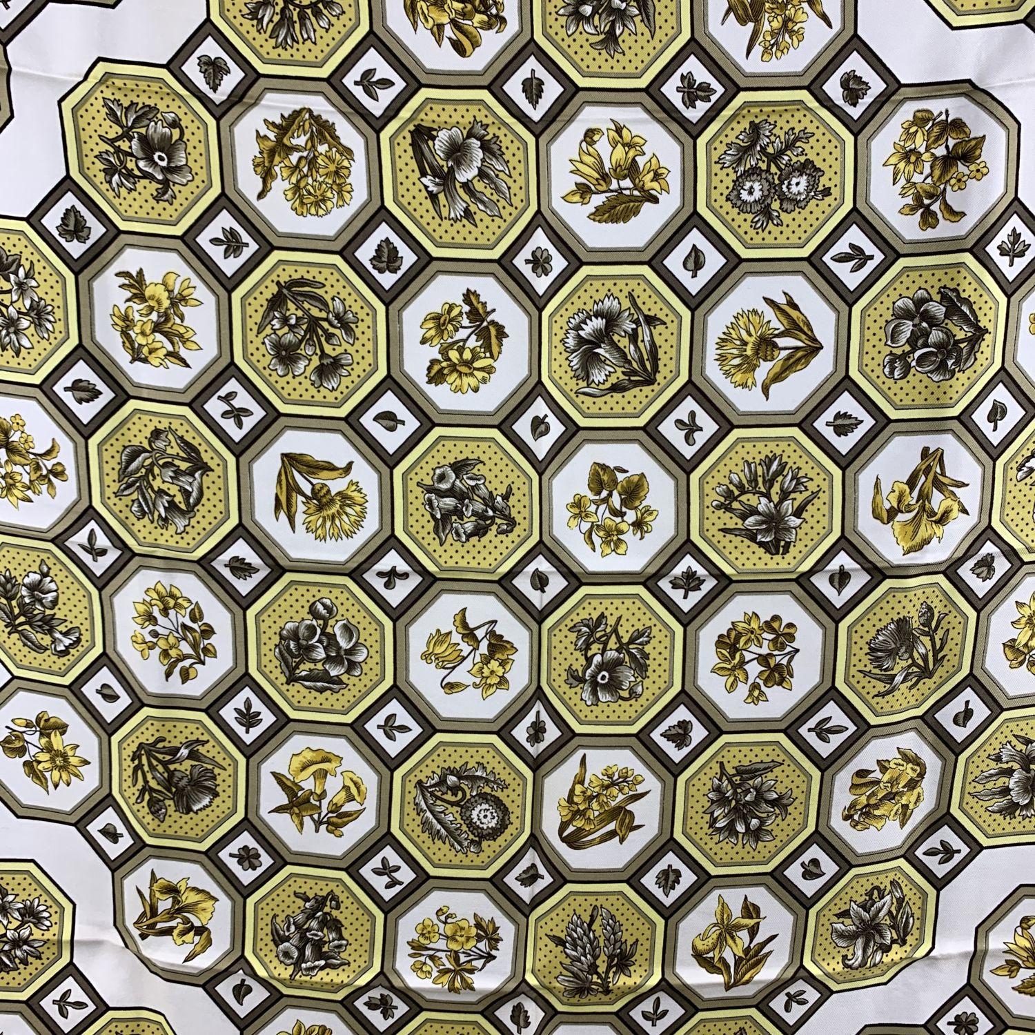 Rare vintage silk scarf named 'Carrelages' ('Tiles') designed for Hermes by Maurice Tranchant. This scarf was issued for the first time in 1968. 100% Silk. Main colors are yellow, white and beige. Hand rolled edges. Approx. measurements: 35 x 35