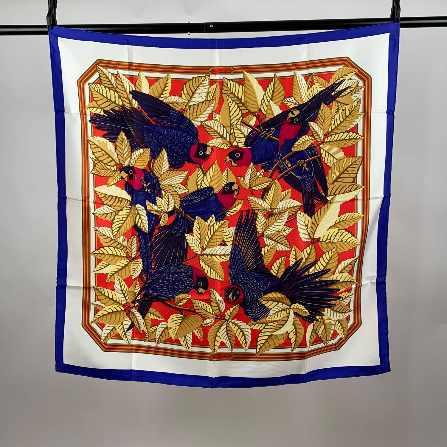 Rare Hermes 'LES PERROQUETS' (The Parrots)silk scarf designed by Joachim Metz  and originally issued in 1984, in different colours, formats and variations of. It features a splendid bold and brilliant design of blue perrots and yellow gold leaves.