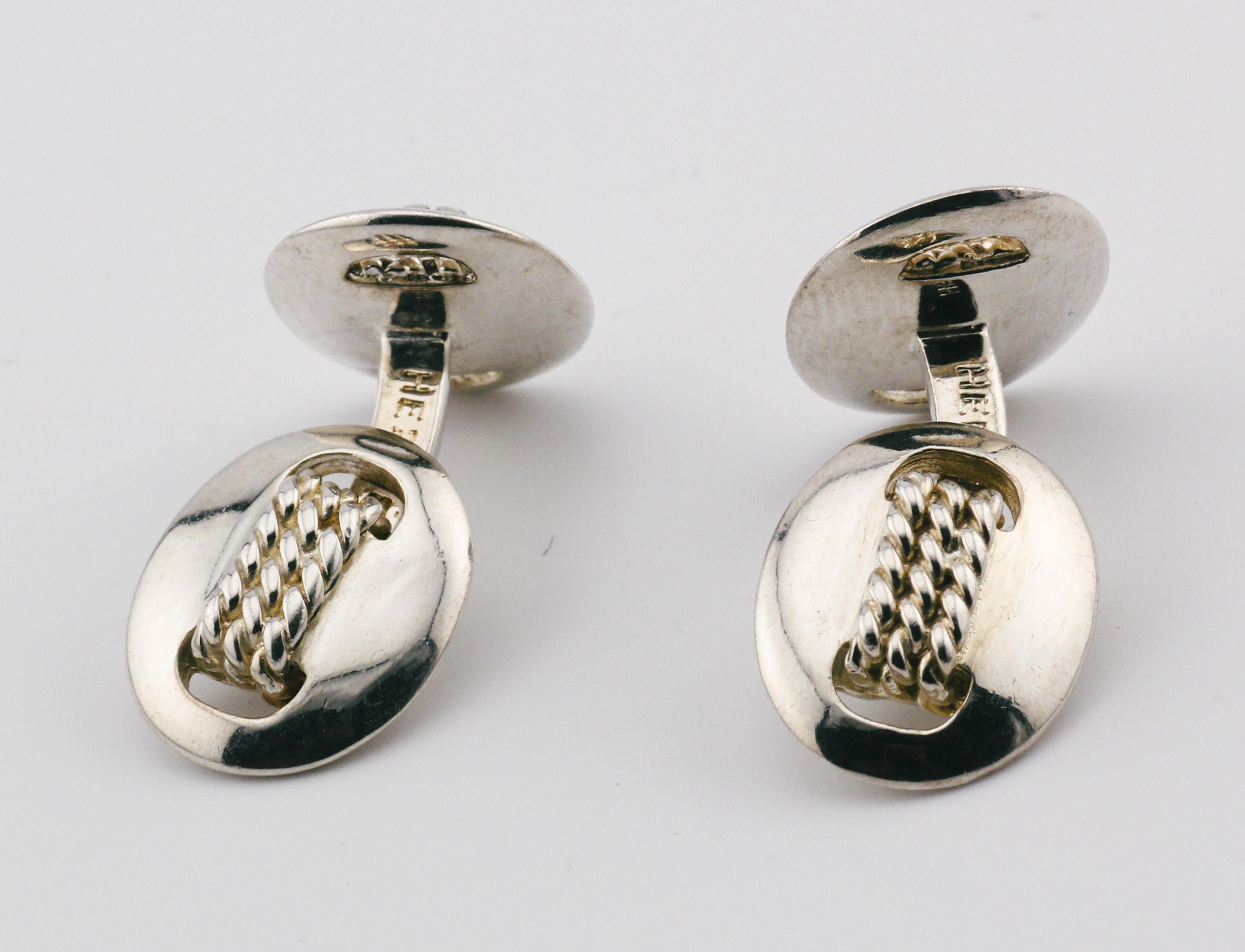 Introducing the epitome of timeless elegance and sophistication: Hermes Vintage Sterling Silver Rope Motif Cufflinks. Crafted to perfection, these exquisite cufflinks are a testament to Hermes' legacy of luxury and impeccable craftsmanship.

Each