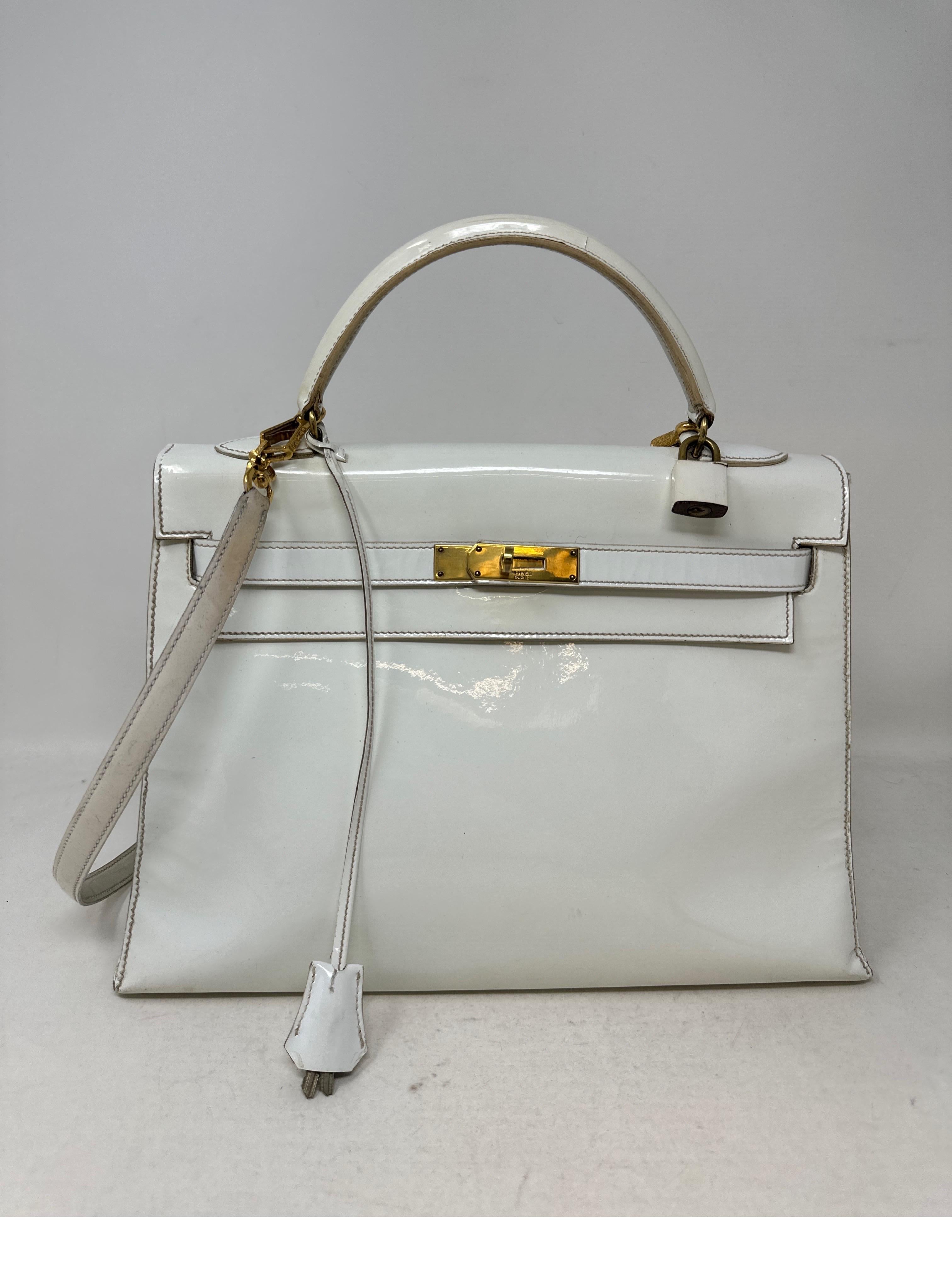 Hermes White Patent Leather Kelly Bag. Vintage rare bag from the 1960's. Collector's piece. Interior has some wear from age. Exterior has light wear from use and age. Please see all photos. For its age in good condition overall. Includes clochette,