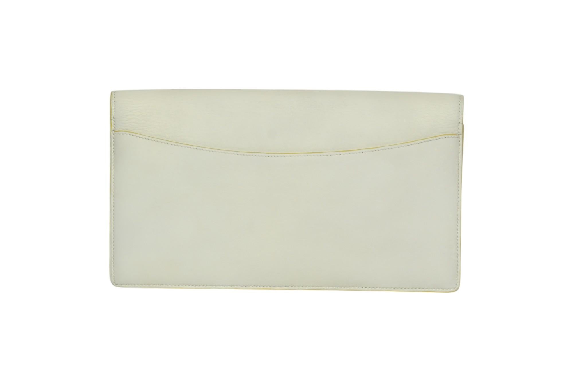 A rare and refined vintage find, this Hermès envelope clutch features smooth white leather in a sleek silhouette with tonal topstitching and the signature “H” logo patch on the flap. Clean lines and minimalist styling make it a timeless choice for