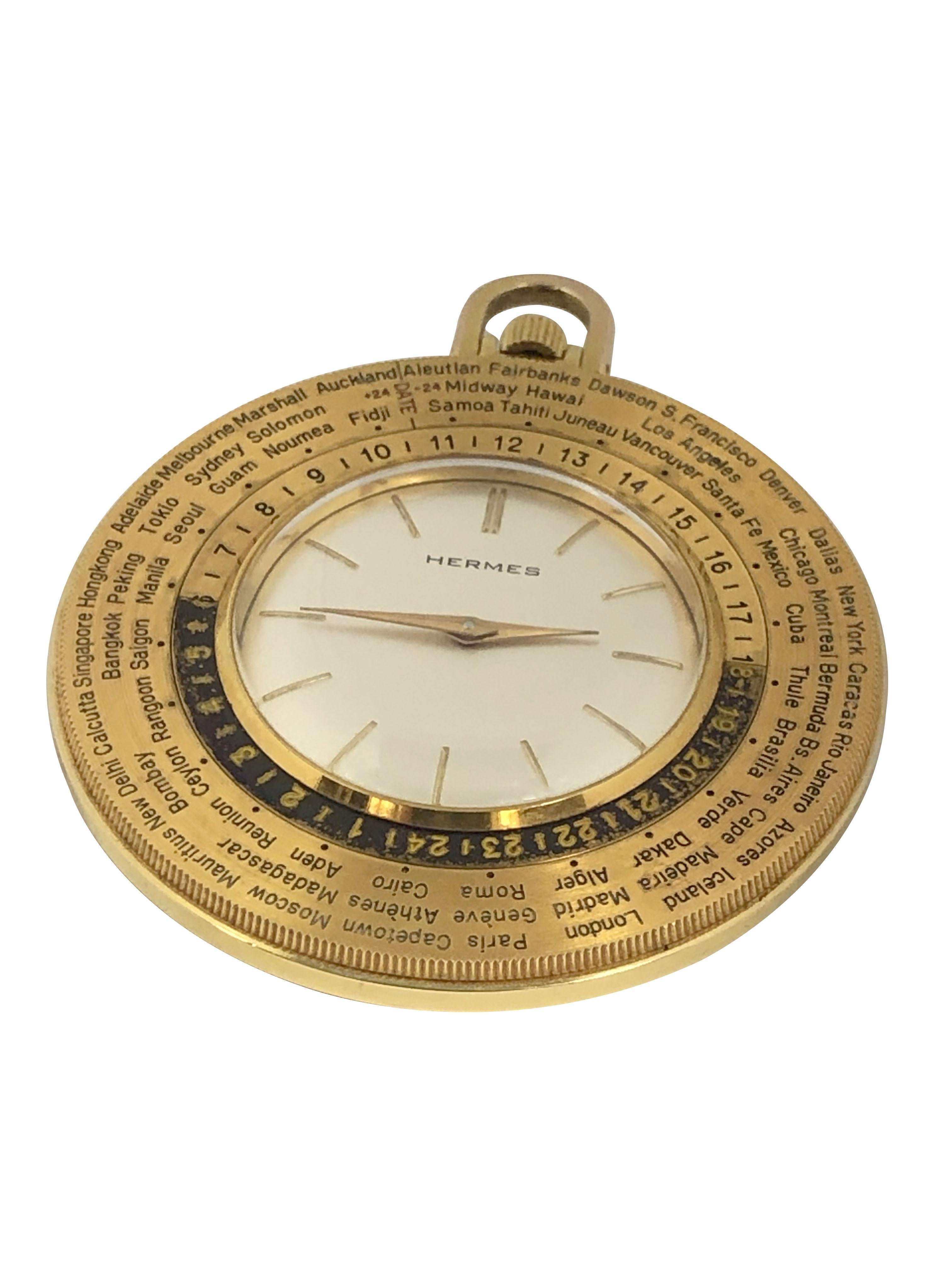 Circa 1970s Hermes Paris Pocket Watch, 52 M.M. 3 piece Gold tone case with Coin Edge, 17 Jewel Mechanical, Manual wind nickle lever movement, Silver Satin dial with raised Gold markers. Wide Rotating Bezel Featuring Cities of the World, each City