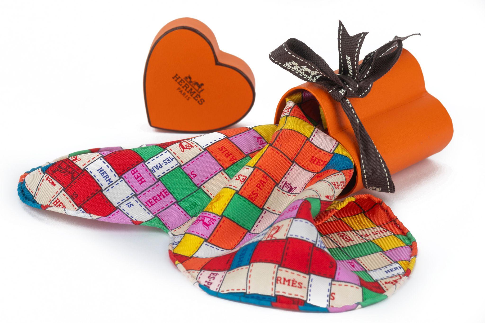 Hermes limited edition mini heart multicolor ribbon scarf. Hand rolled edges.
Comes with original box.