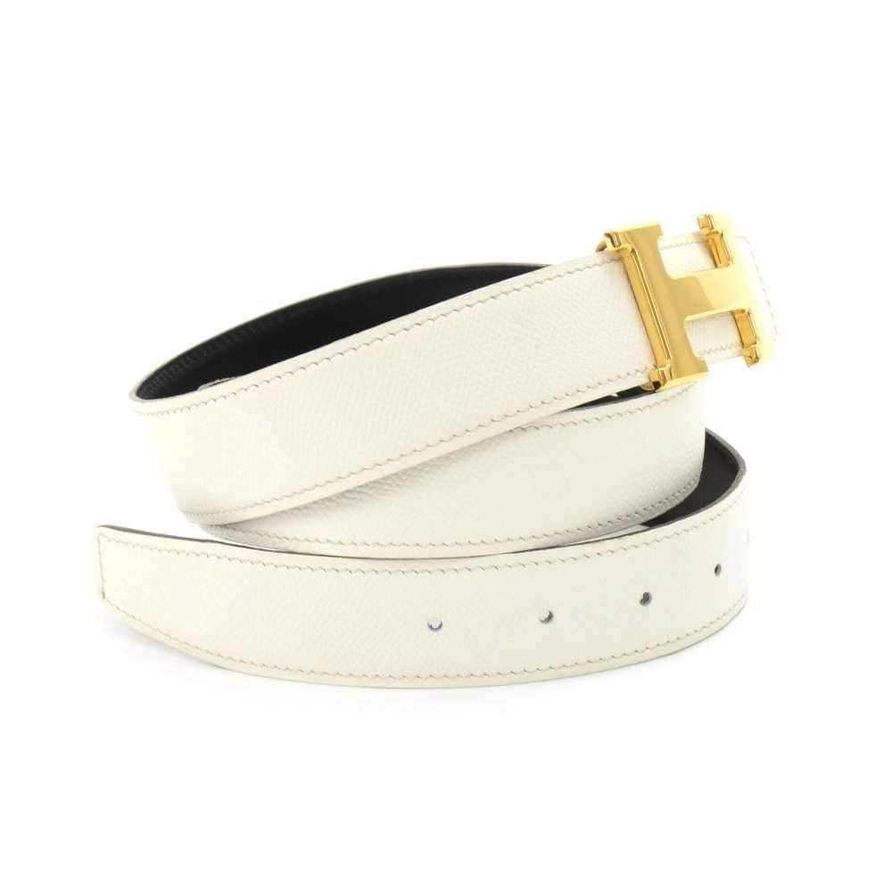 Hermes belt in white and black leather with a gold-tone H buckle. 