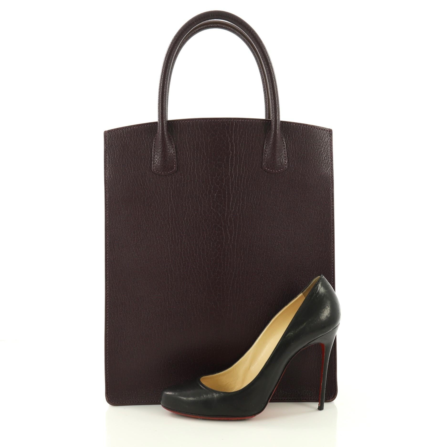 This Hermes White Bus Handbag Leather 30, crafted in purple Raisin leather, features dual rolled handles and gold-tone hardware. It opens to a purple leather interior. Date stamp reads: F Square (2002). **Note: Shoe photographed is used as a sizing