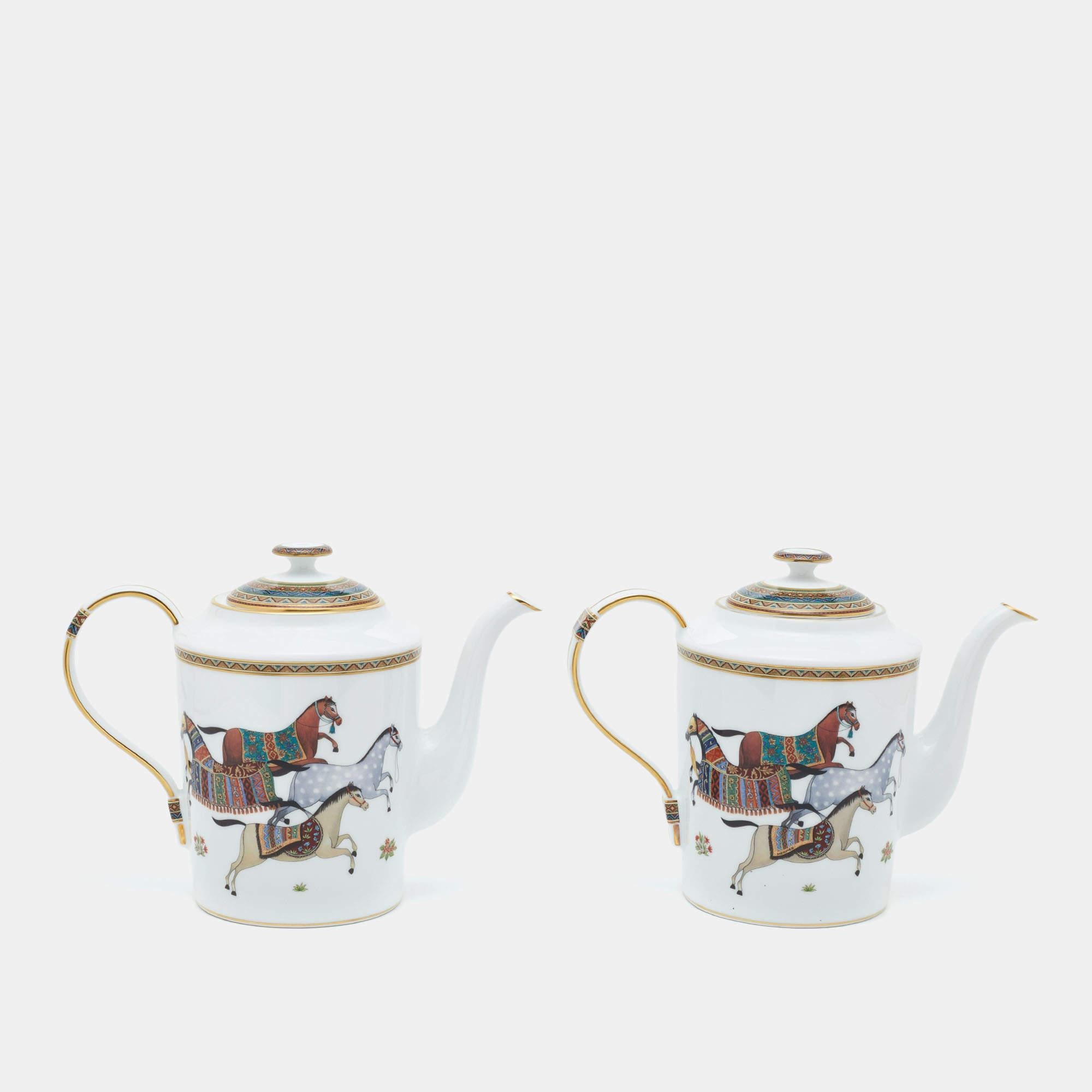 The Hermès teapots set of 2 exudes elegance with its white porcelain adorned by a delicate Cheval d'Orient print. Each teapot is a work of art, featuring intricate details and a timeless design, making them a luxurious addition to any tea lover's