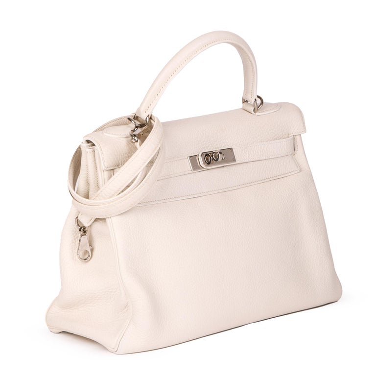 HERMÈS
White Clemence Leather Kelly 32cm Retourne

Xupes Reference: JJLG075
Serial Number: [H]
Age (Circa): 2004
Accompanied By: Hermès Dust Bag, Shoulder Strap, Padlock, Keys, Raincover, Hermès Spa Receipt 
Authenticity Details: Date Stamp (Made in