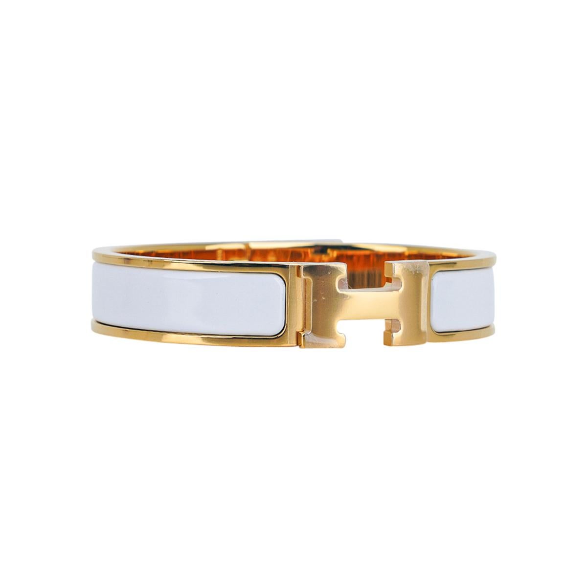 Mightychic offers an Hermes Clic H Bracelet featured in white Enamel.
Set in Gold plated hardware.
Chic, modern and unmistakably Hermes!
A hinged band allows the H to swivel and open the bracelet.
Comes with pouch and signature Hermes box.
NEW or