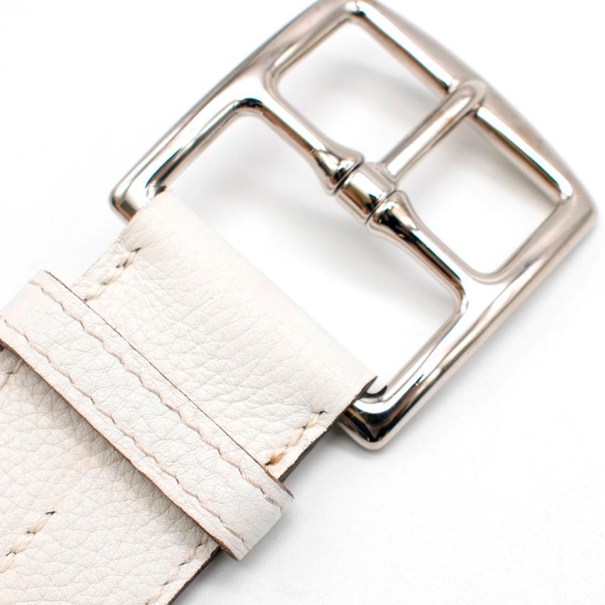 Hermes White Leather Belt with Double Tour buckle and tone stitching. 

- Silver closure 
- Tan interior 
- Adjustable 5 holes 
- Pointed edge 
- Grained Leather exterior 

- Made in France 

Please note, these items are pre-owned and may show signs