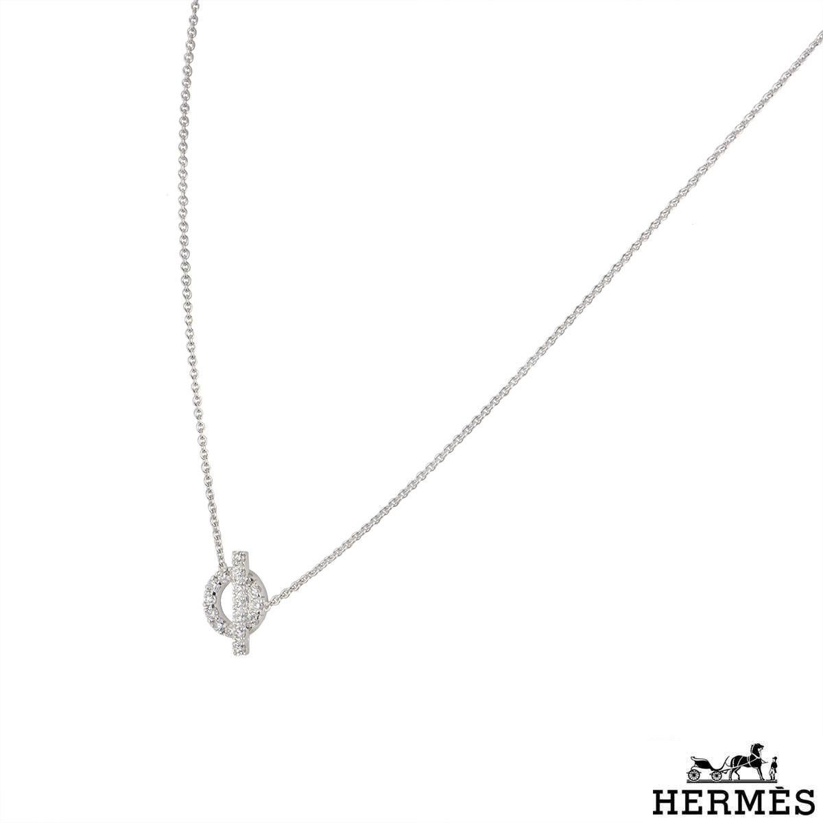An 18k white gold diamond necklace by Hermes from the Finesse collection. The necklace features a circular motif with a bar across it set with pave round brilliant cut diamonds. The 19 diamonds have a total weight of 0.57ct. The necklace has a