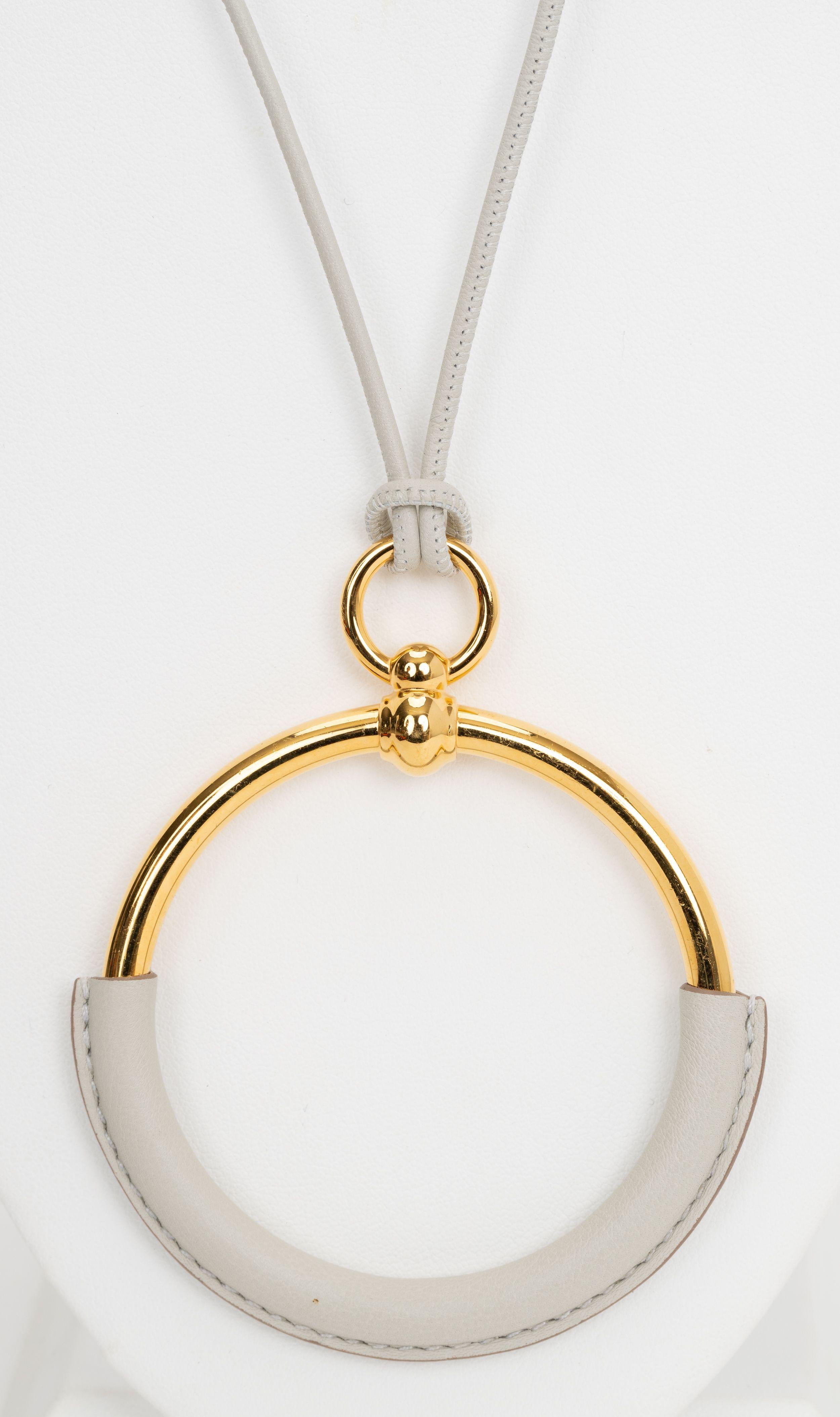 The Hermès White Leather Loop Pendent Necklace is a timeless statement piece. Features a simple but elegant pendant, D 3