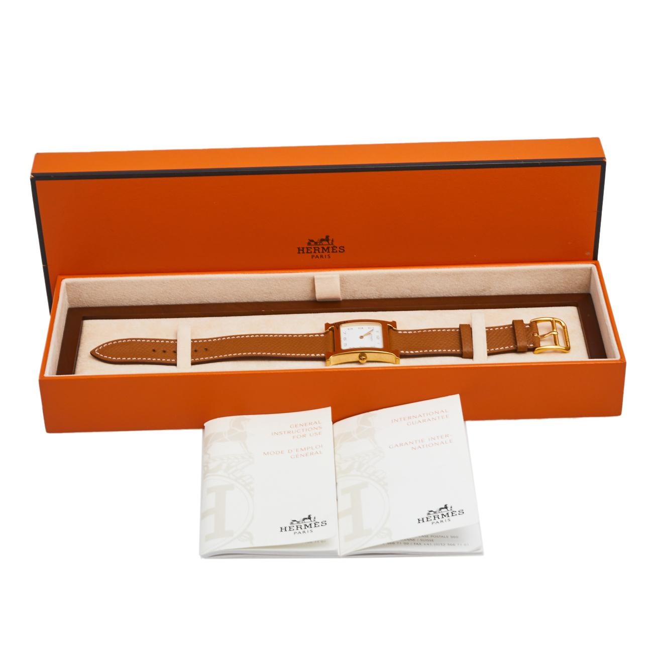 This Heure H watch from Hermes stands for quality and sophistication. The watch features a signature 'H' case in gold-plated stainless steel and held by leather straps with buckle fastenings. Powered by quartz movement, this elegant timepiece has a